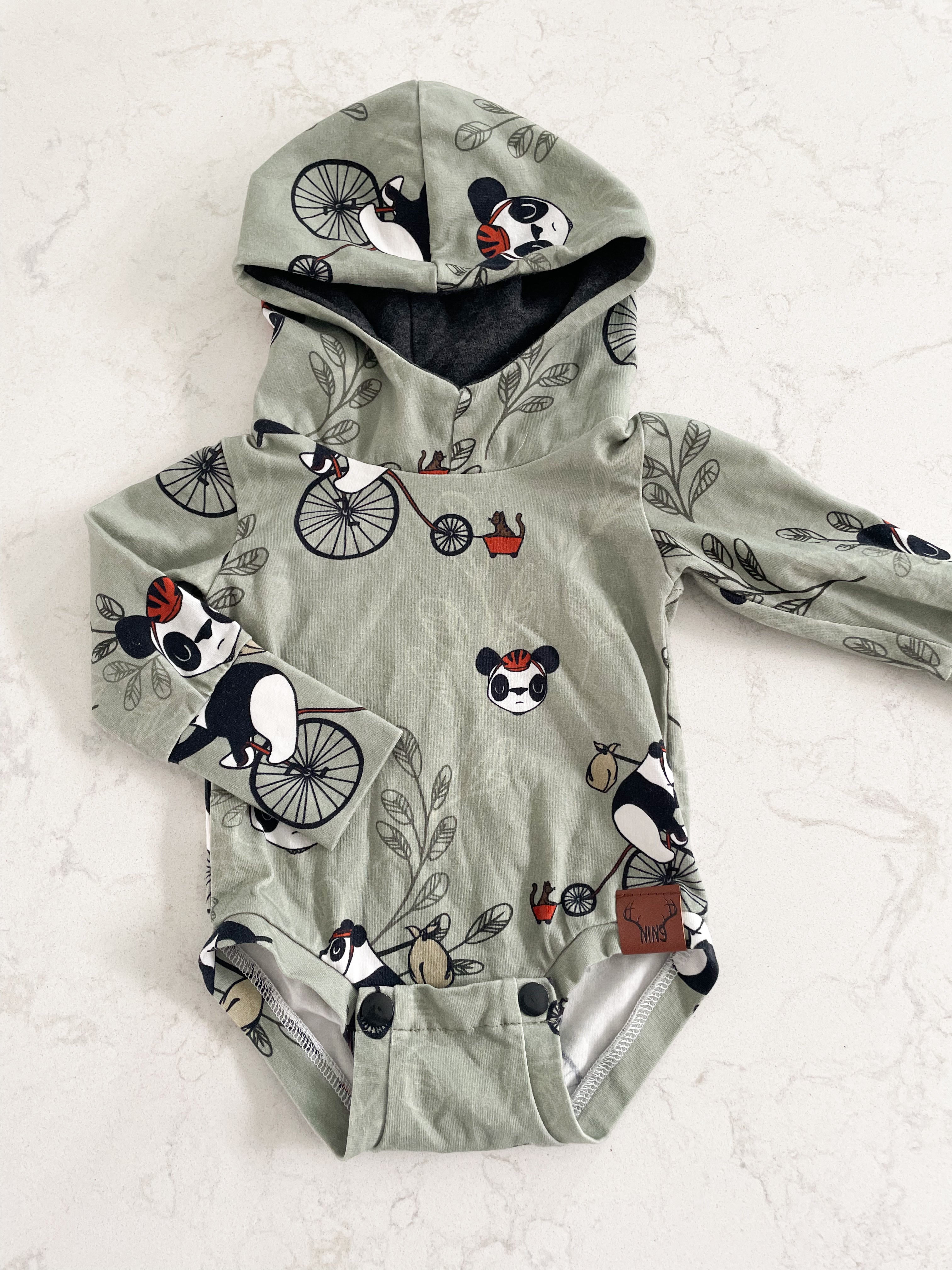 NIN9- 0-6 months- long sleeve hooded bodysuit with pandas riding bikes