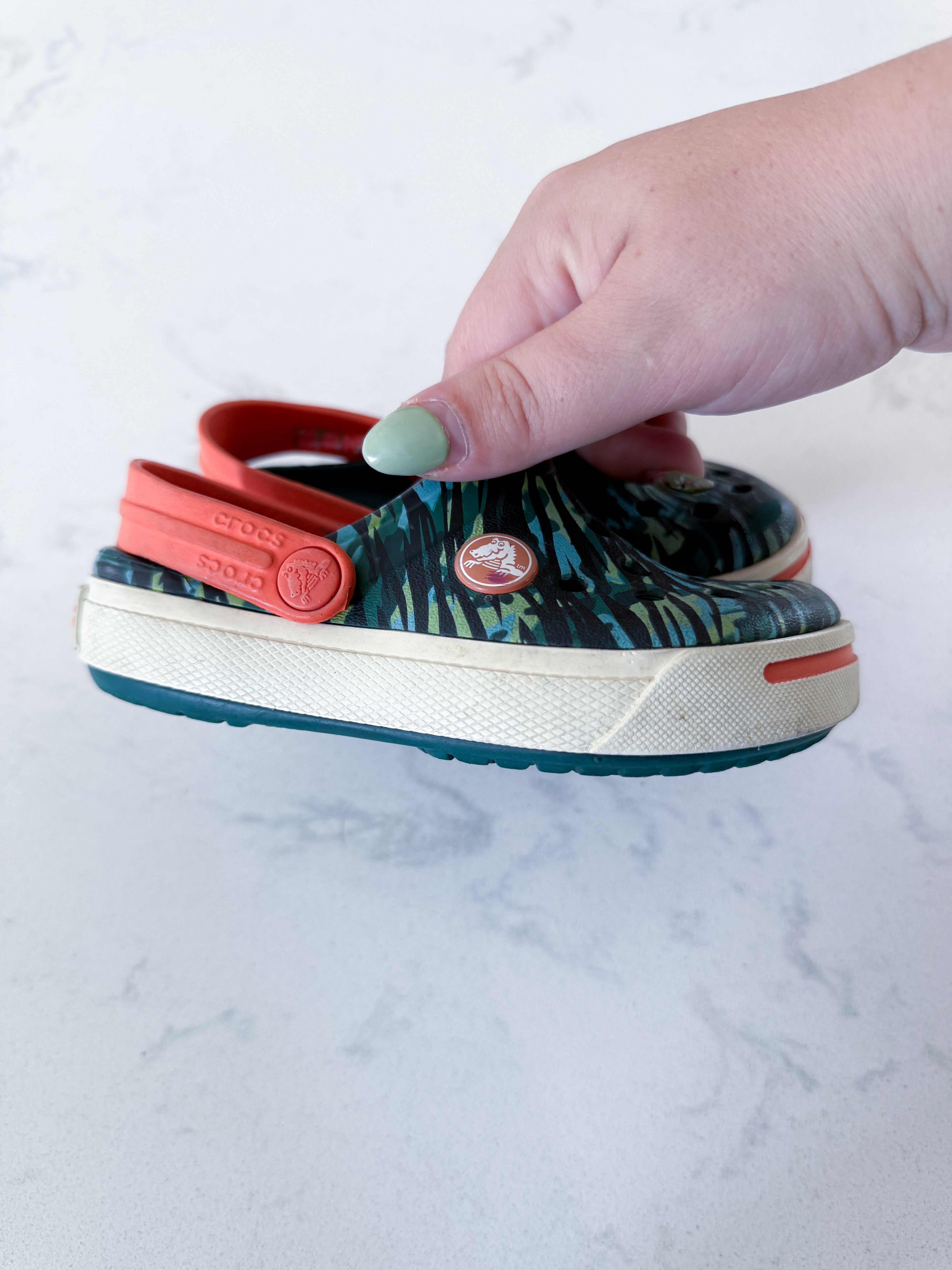 Crocs- 8/9C- GUC- camo slip ons with orange accents