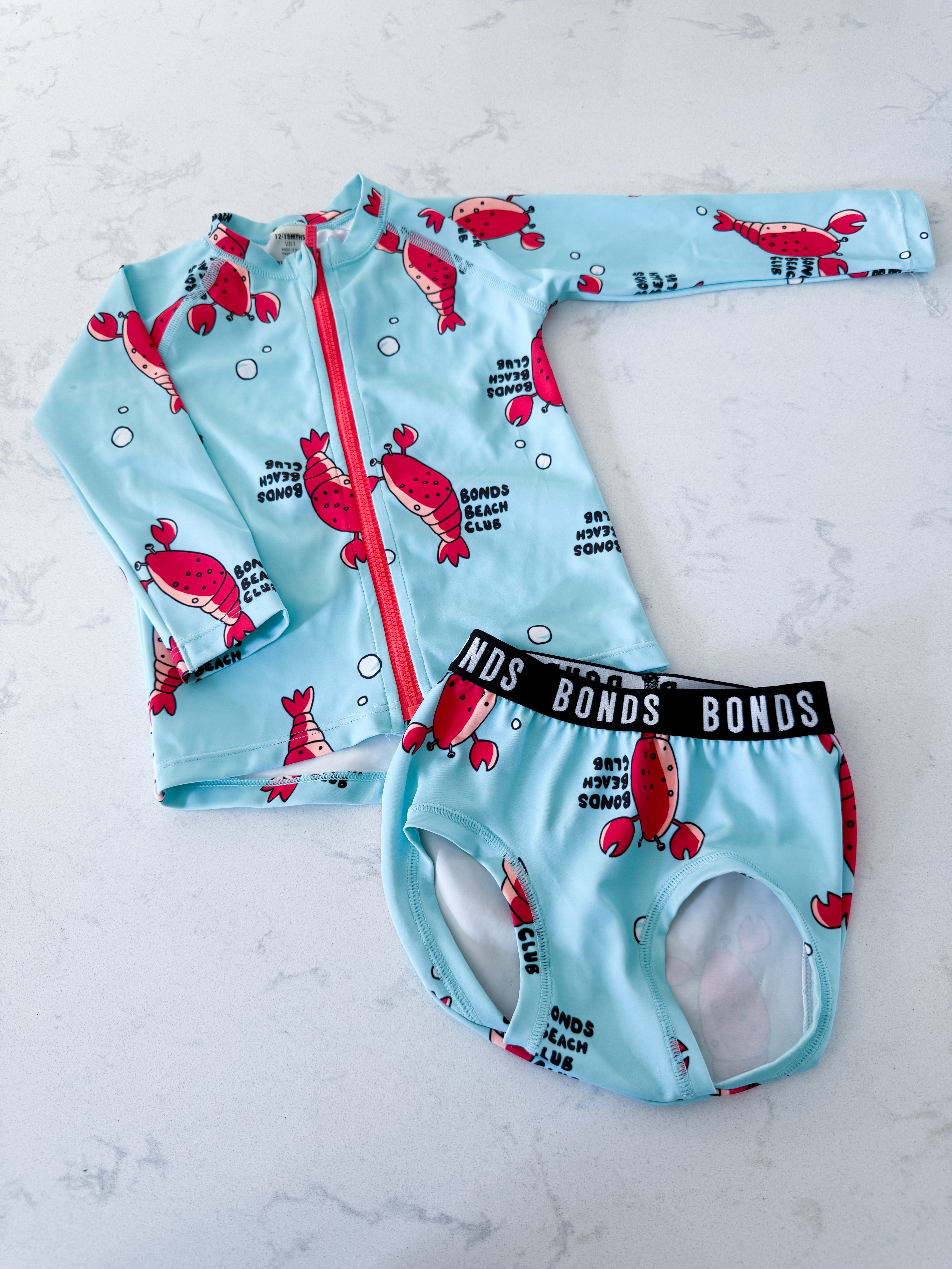 BONDS- 12-18m- PLAY- bright blue two piece swim suit with lobster graphics