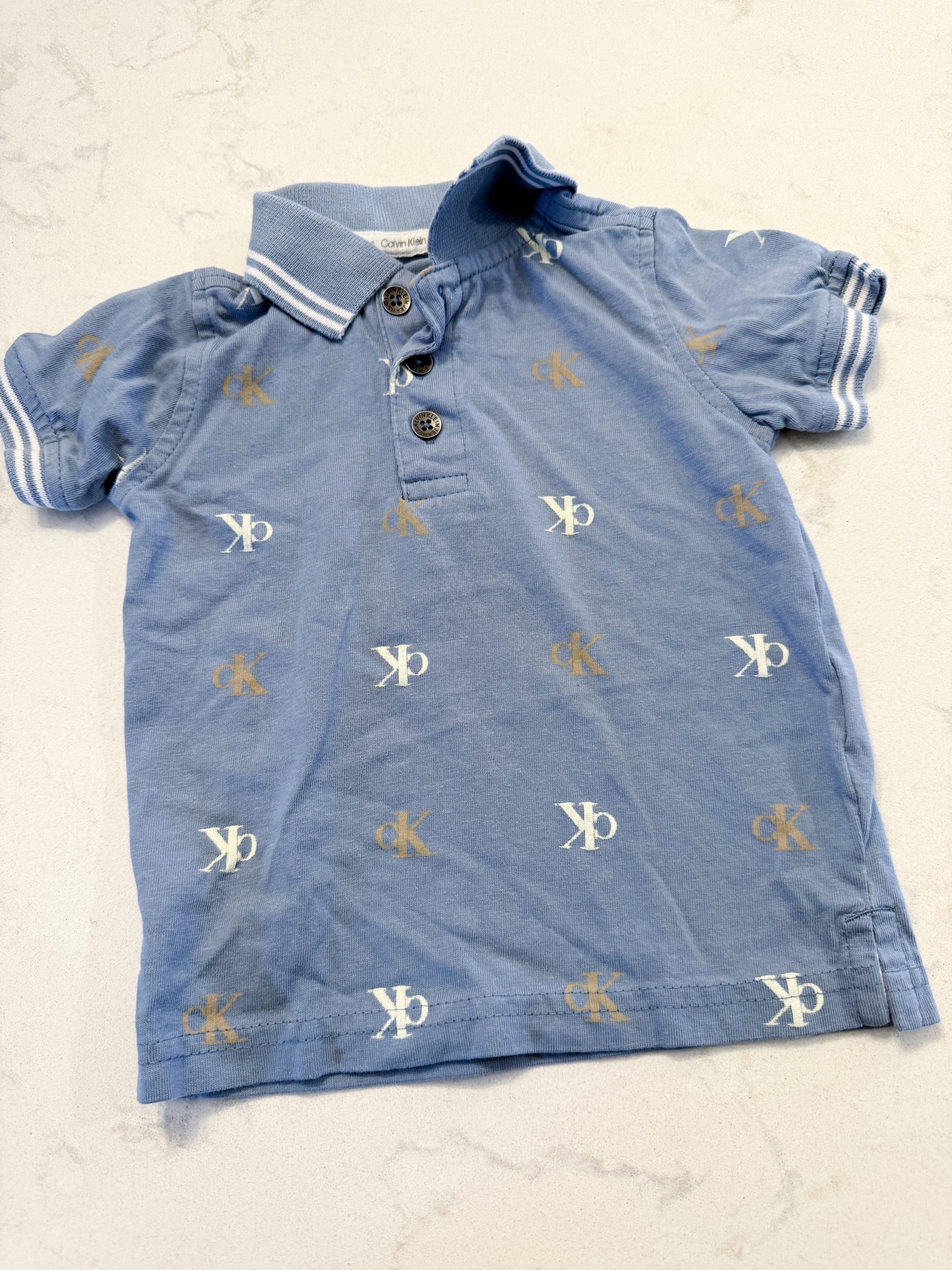 Calvin Klein- 6-9m- GUC- slate blue polo with logo pattern