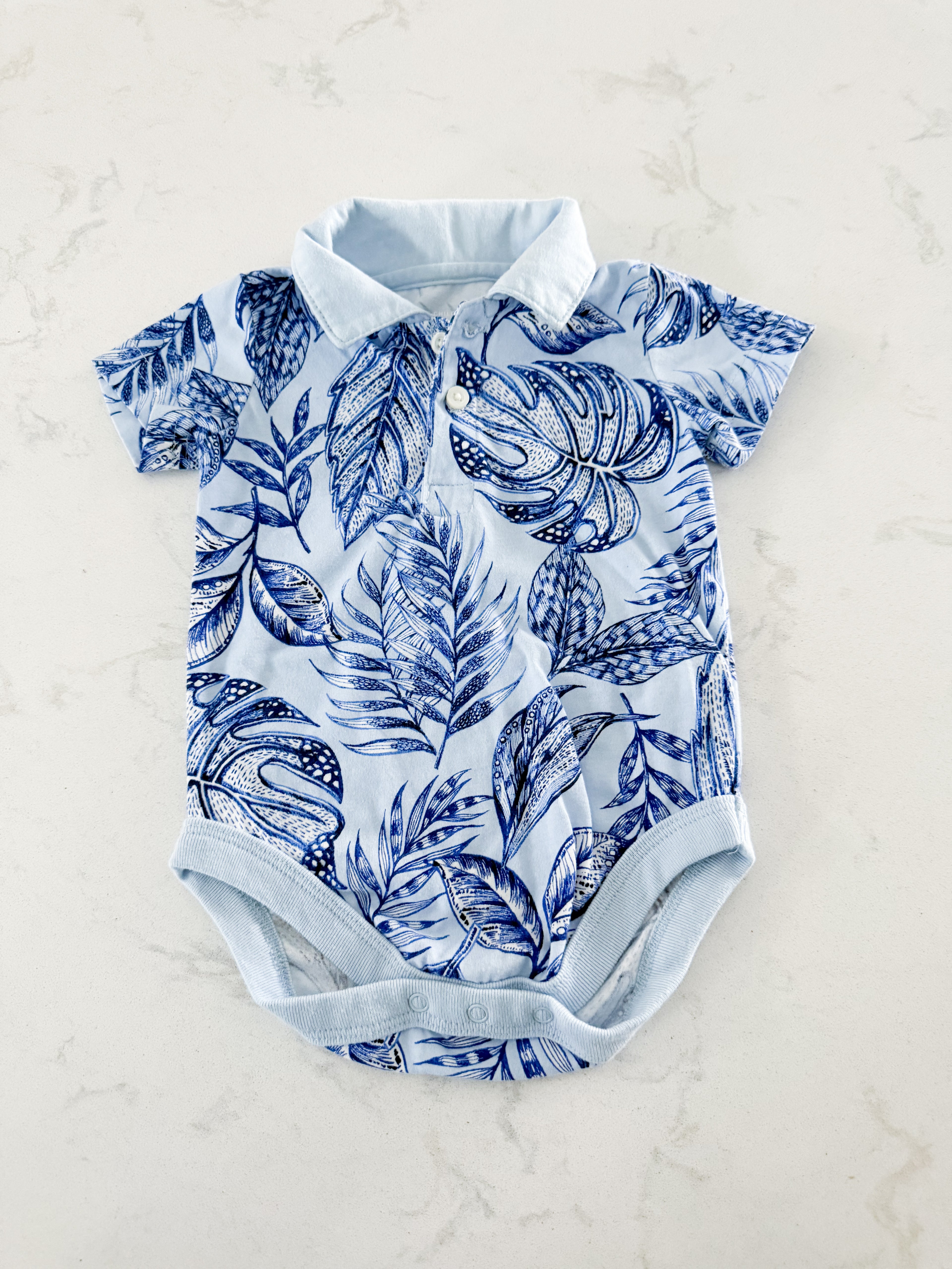 The Children’s Place- 3-6m- VGUC- blue collared bodysuit with tropical leaves