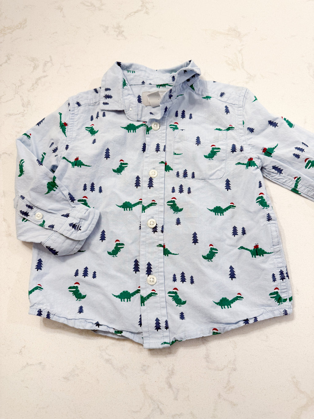 The Children’s Place- 12-18m- PLAY- light blue dress shirt with Christmas Dino’s all over