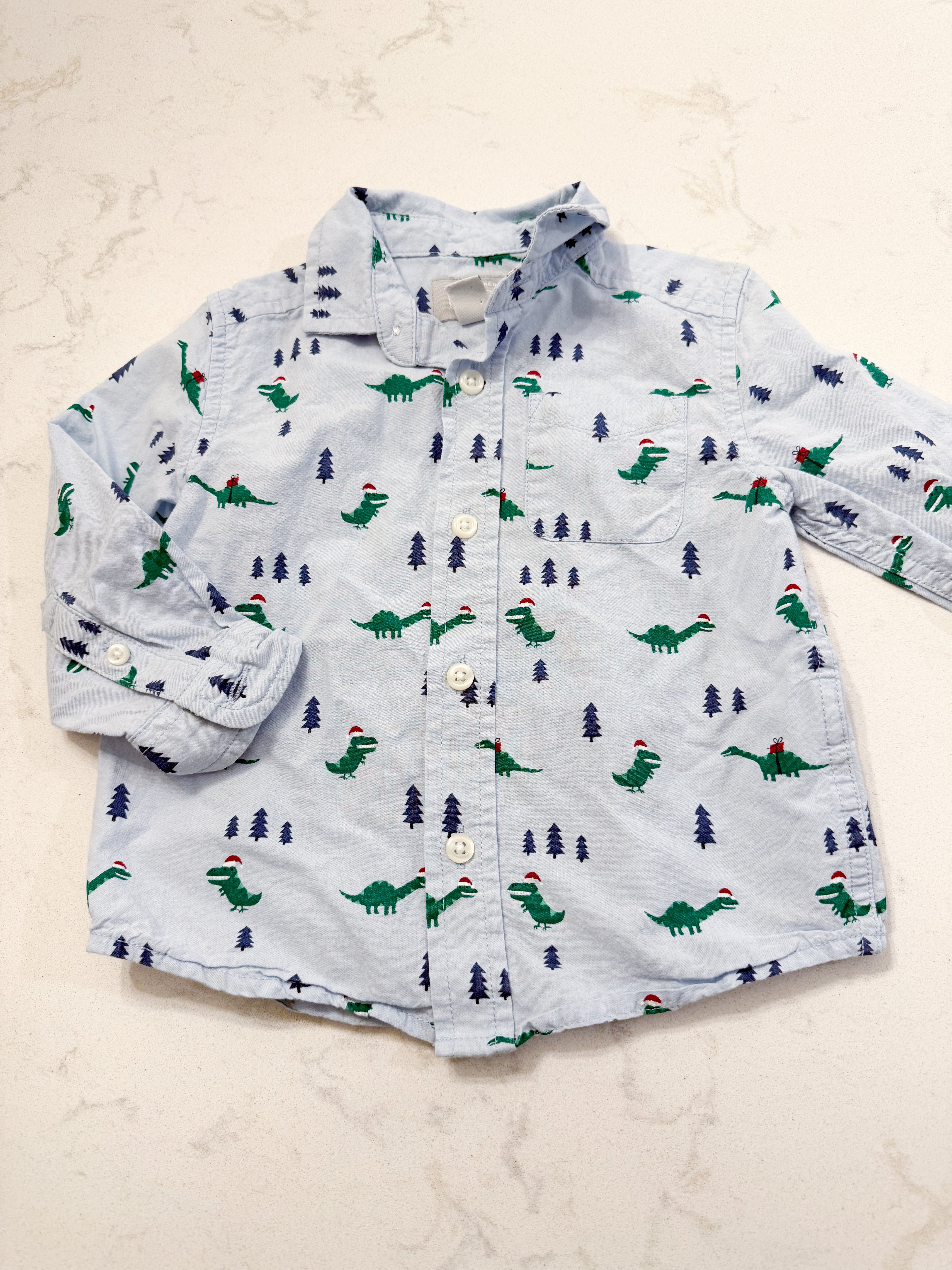 The Children’s Place- 12-18m- PLAY- light blue dress shirt with Christmas Dino’s all over