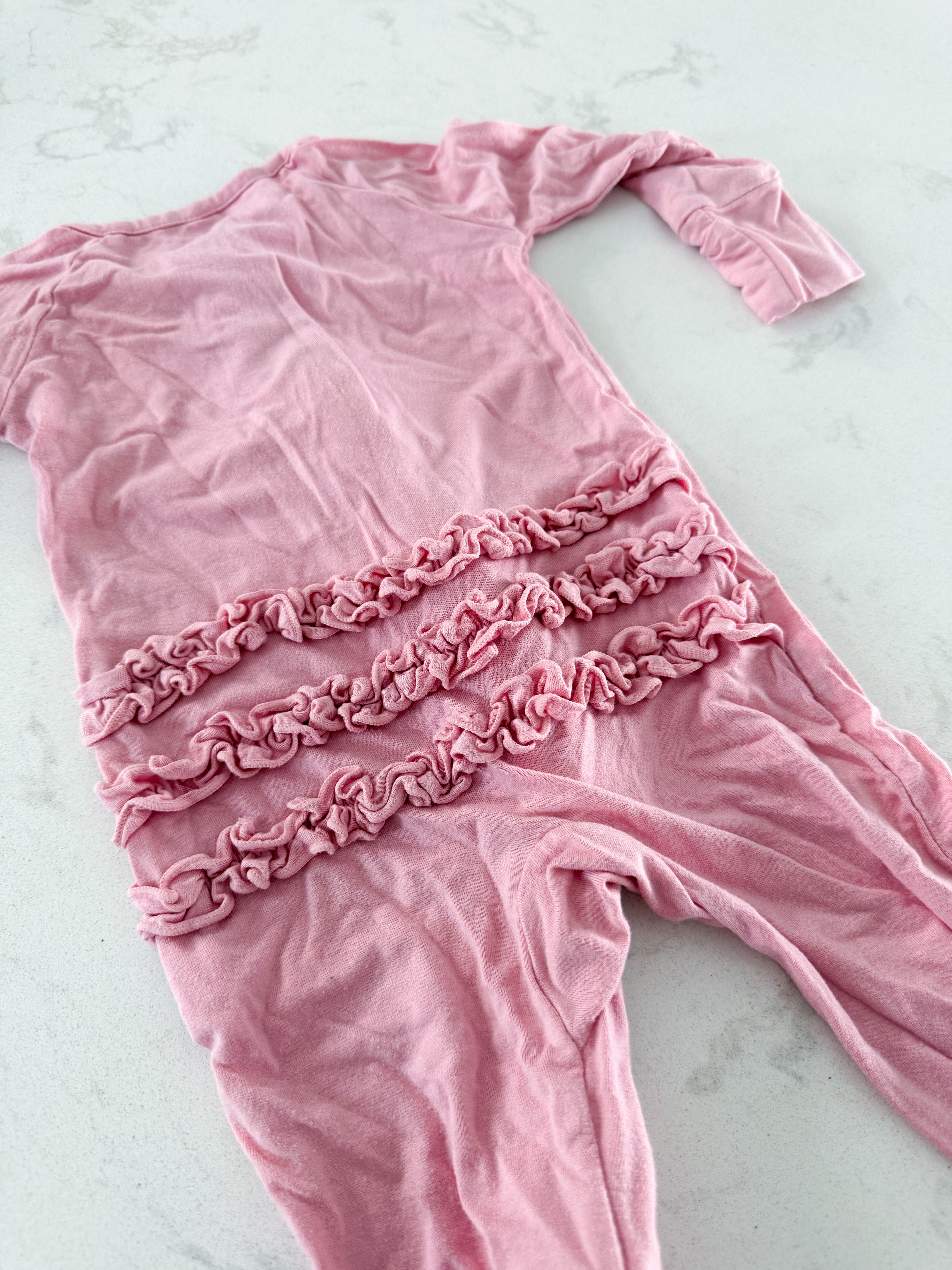 Little Sleepies- 0-3m- GUC- pink zip up bamboo footie with ruffle bum