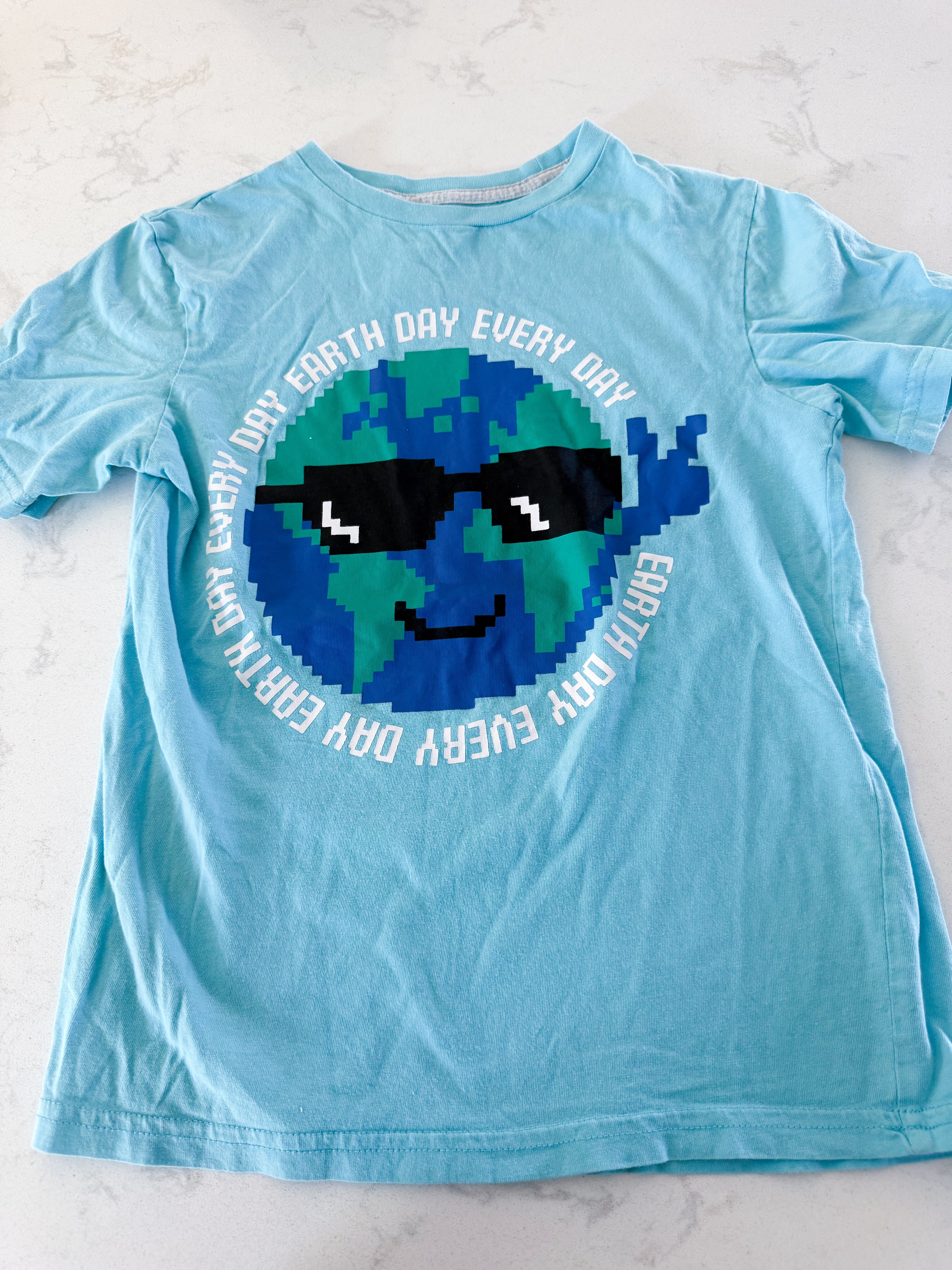 George- 7/8Y- GUC- blue t shirt with pixelated earth wearing sunglasses