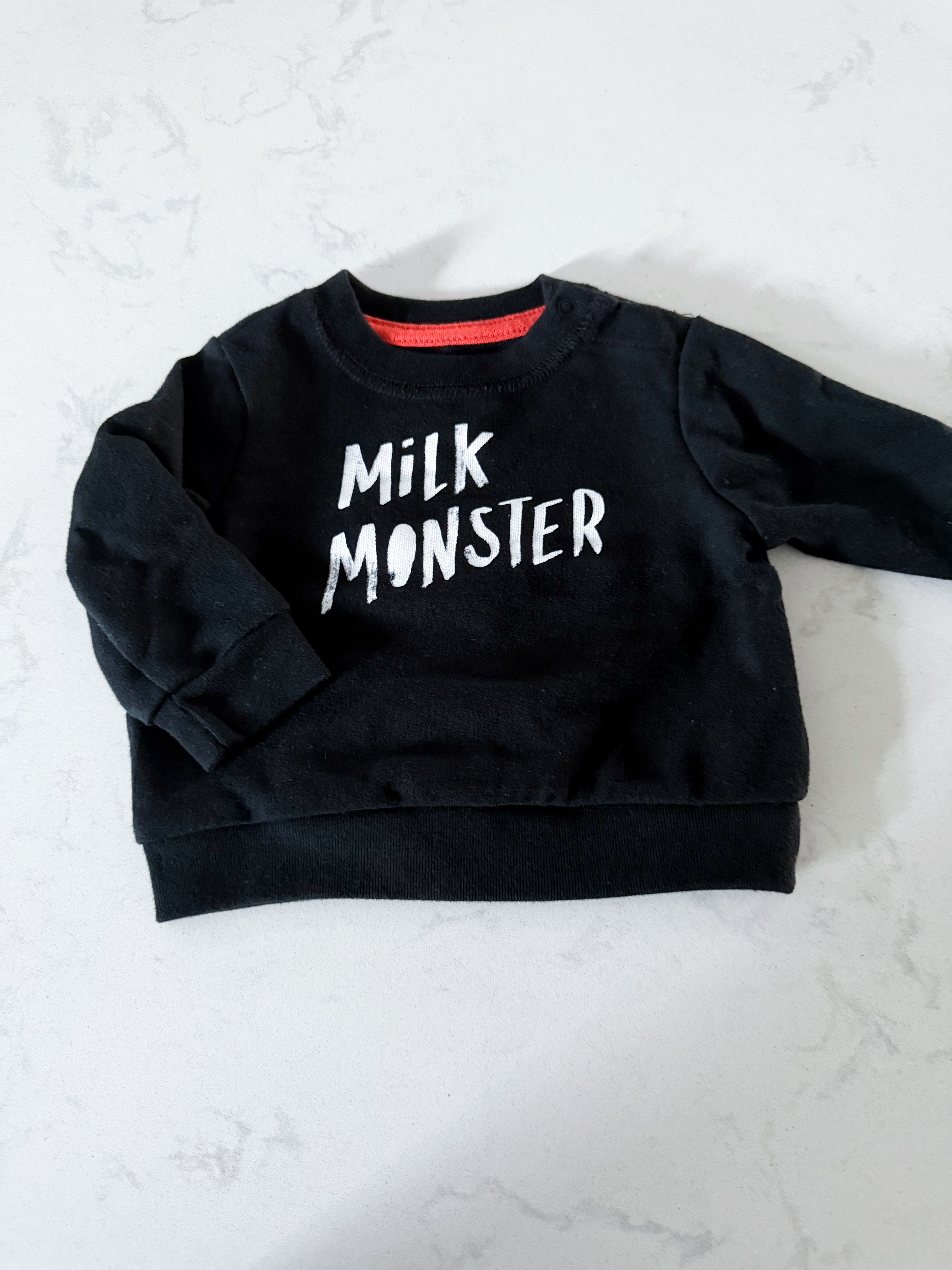 Cat and Jack- 0-3m- VGUC- black crewneck with “milk monster”