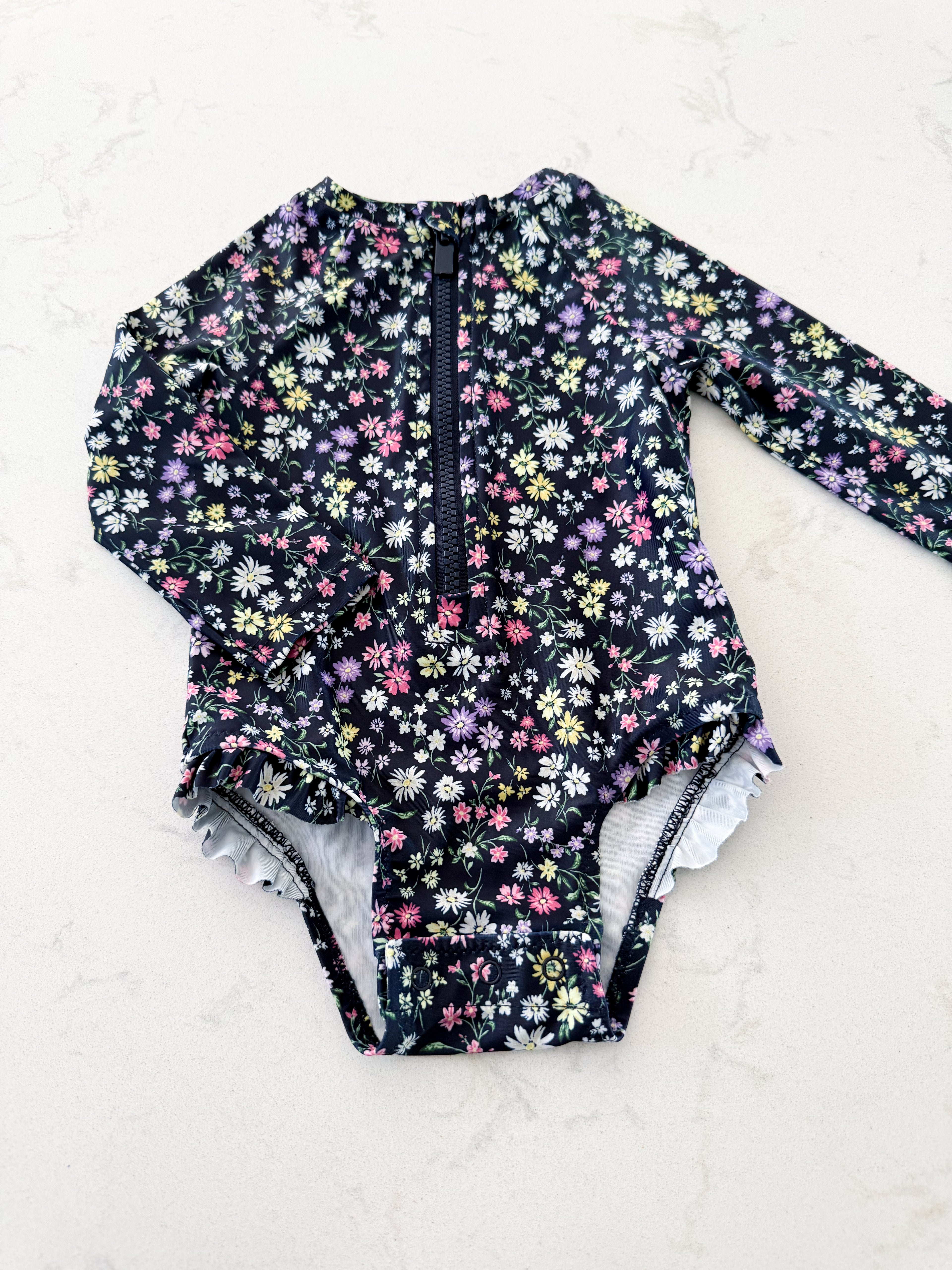Old Navy- 6-12m- VGUC- navy blue long sleeve swim suit with tiny colourful florals