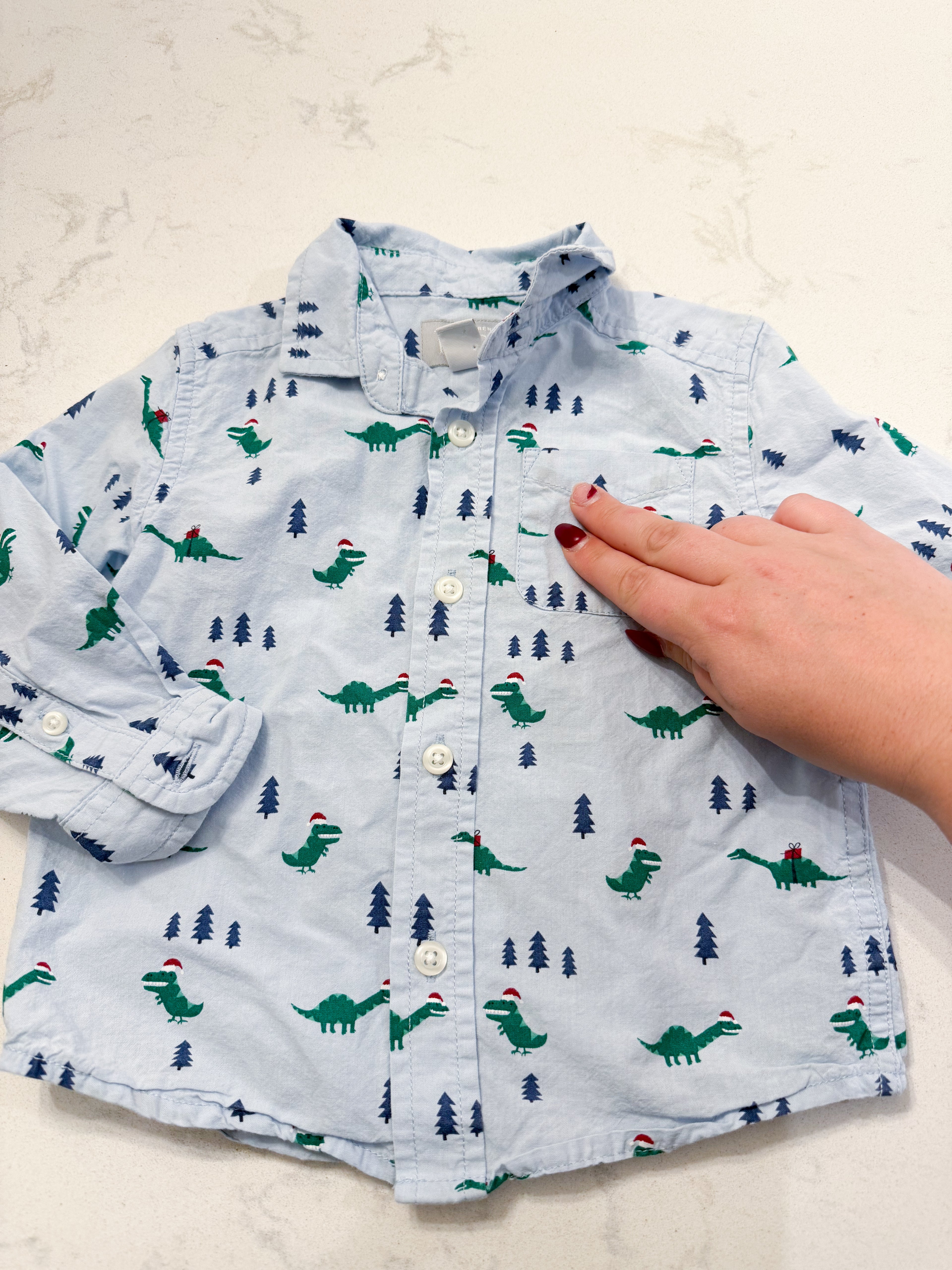 The Children’s Place- 12-18m- PLAY- light blue dress shirt with Christmas Dino’s all over