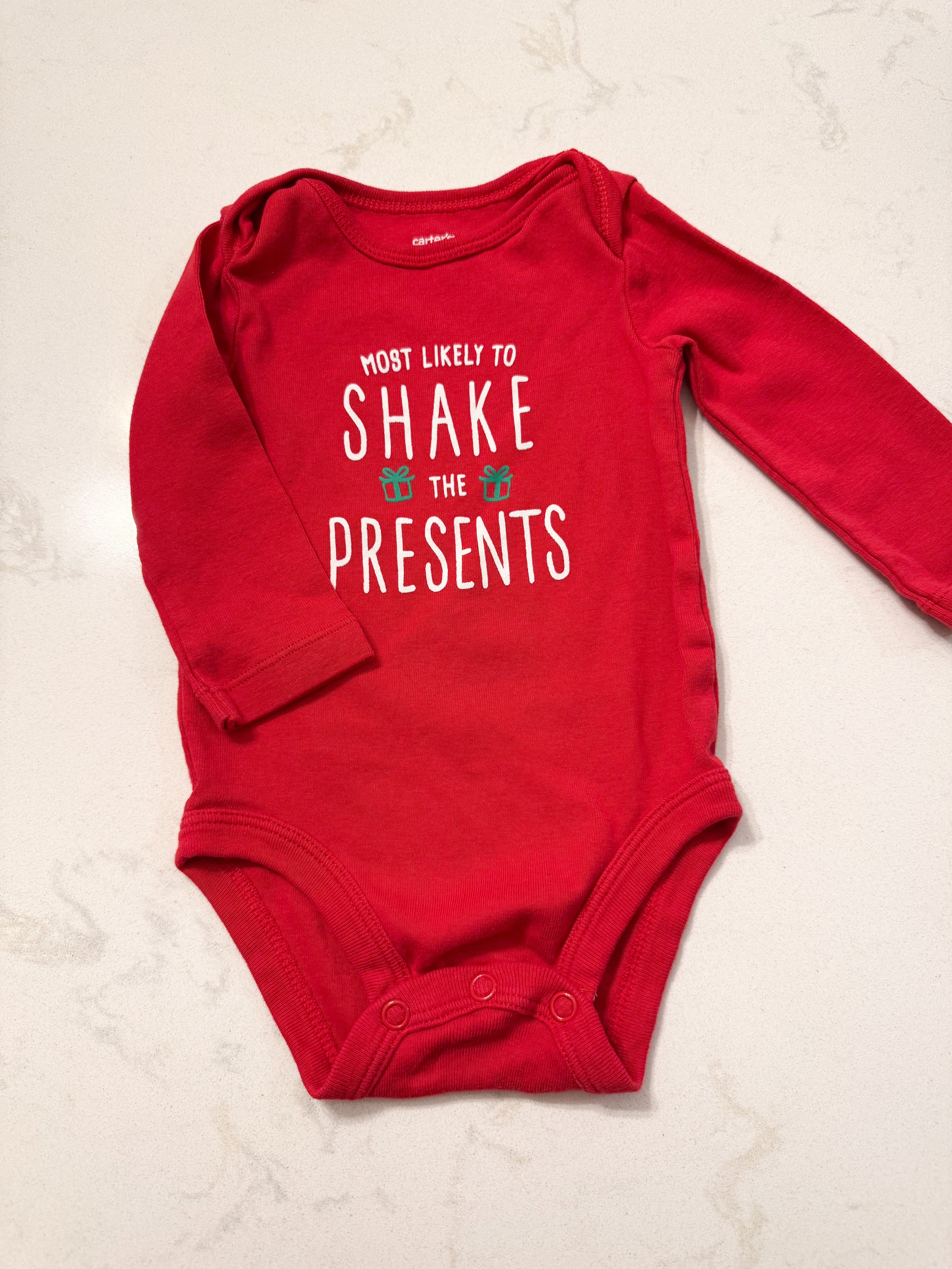 Carter’s- 6m- VGUC- long sleeve red bodysuit with « most likely to shake the presents »