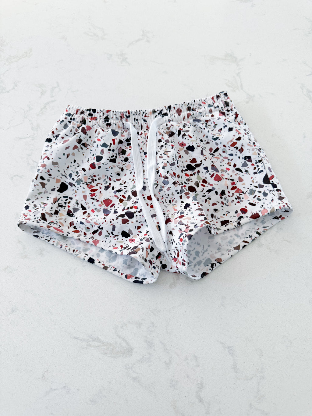 Current Tyed- 6/7Y- VGUC- white European style swim trunks (boardies) with pebble pattern
