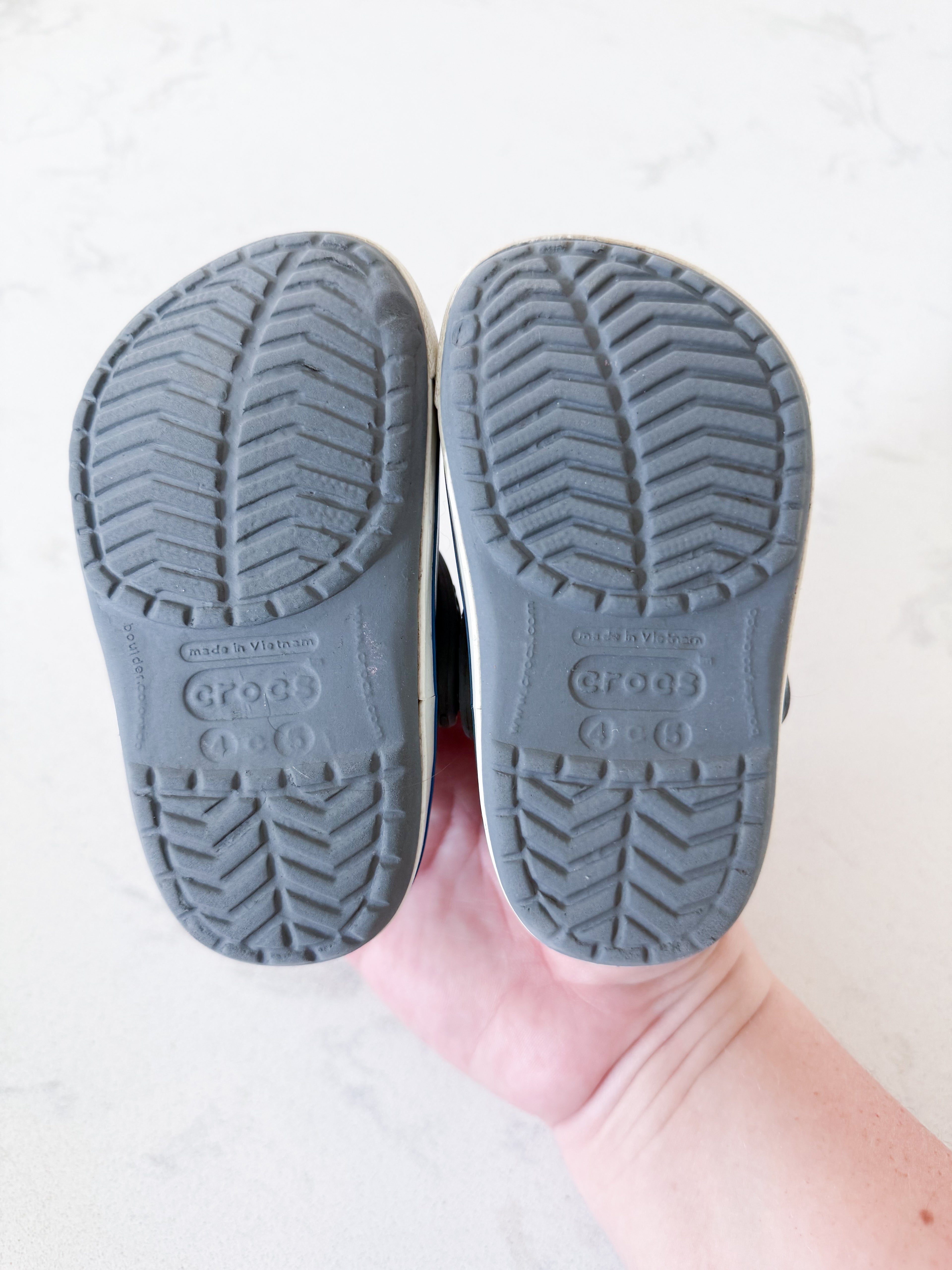 Crocs- 4/5C- GUC- grey slip on crocs with white trim