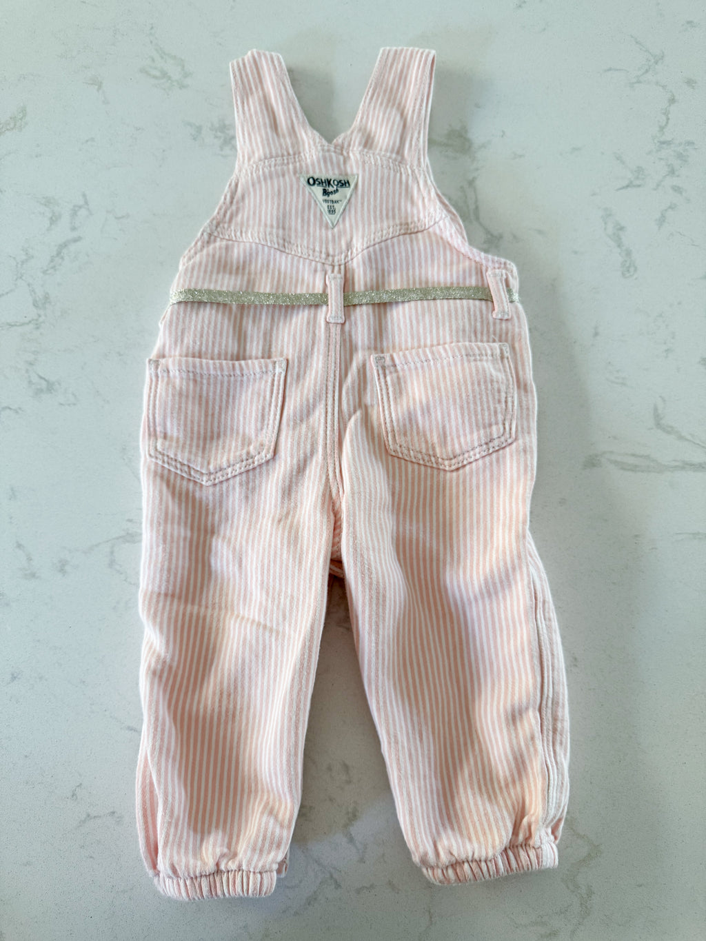 Oshkosh- 12m- GUC- light pink and white striped cloth overalls