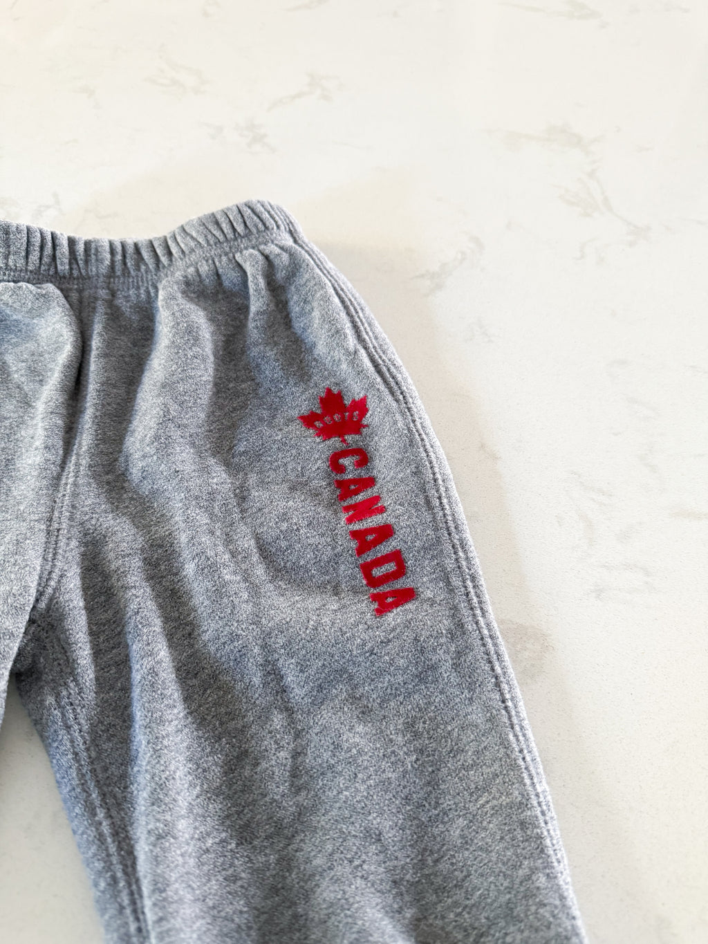 Roots-6-12m- GUC- grey sweats with Canada felt writing