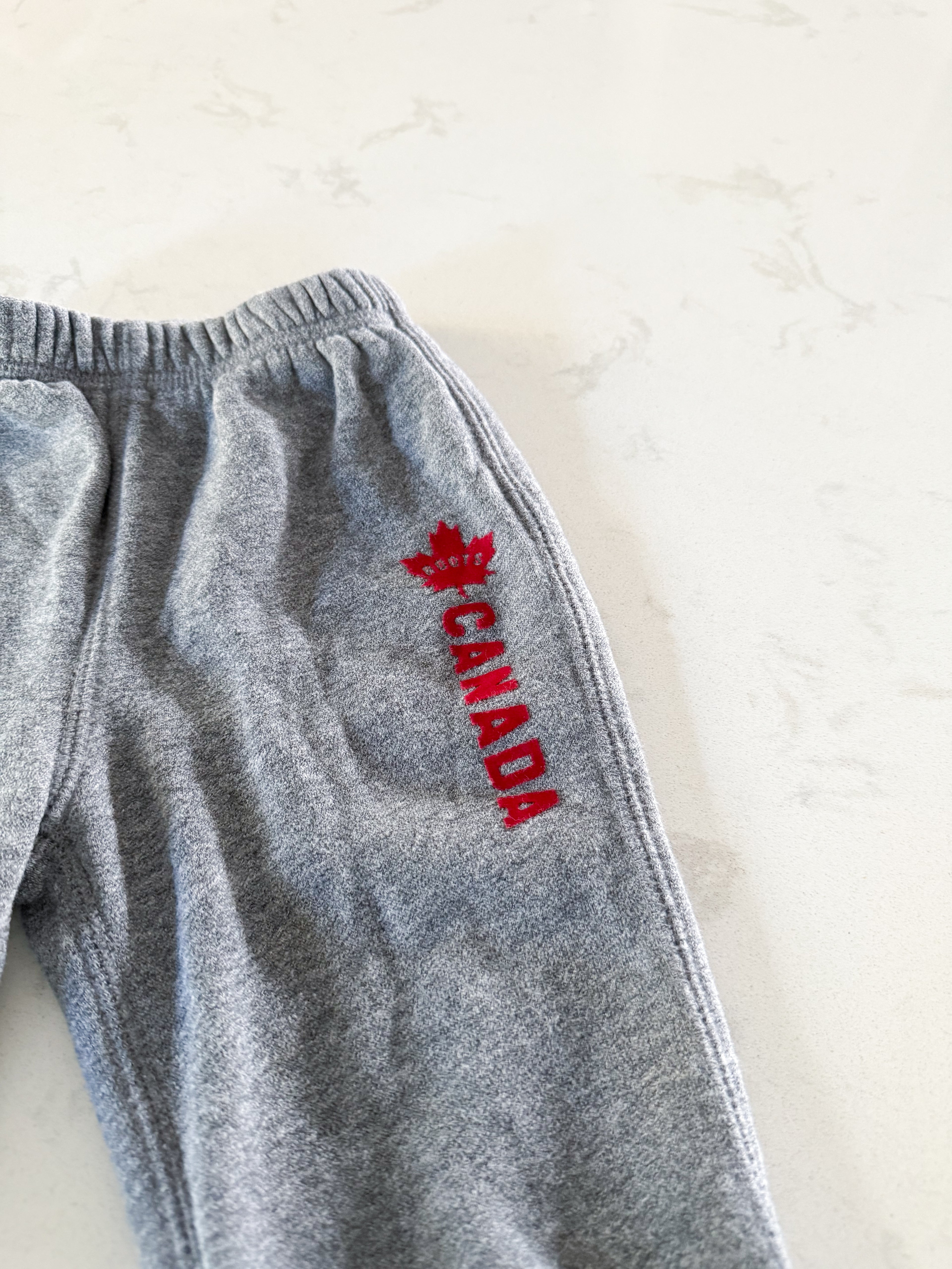 Roots-6-12m- GUC- grey sweats with Canada felt writing