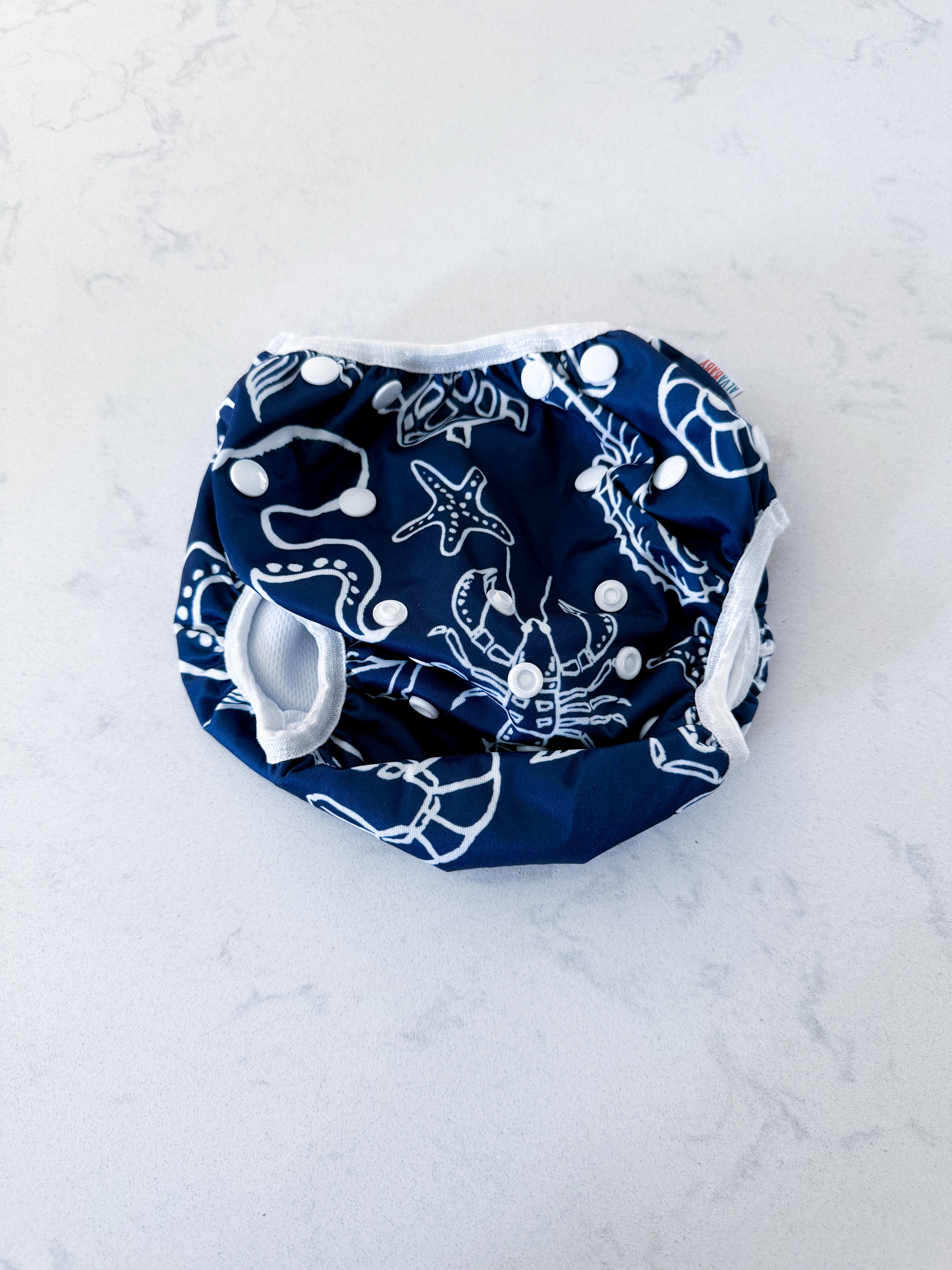 Alva Baby- adjustable- swim diaper with navy blue swim diaper with White Sea creature pattern