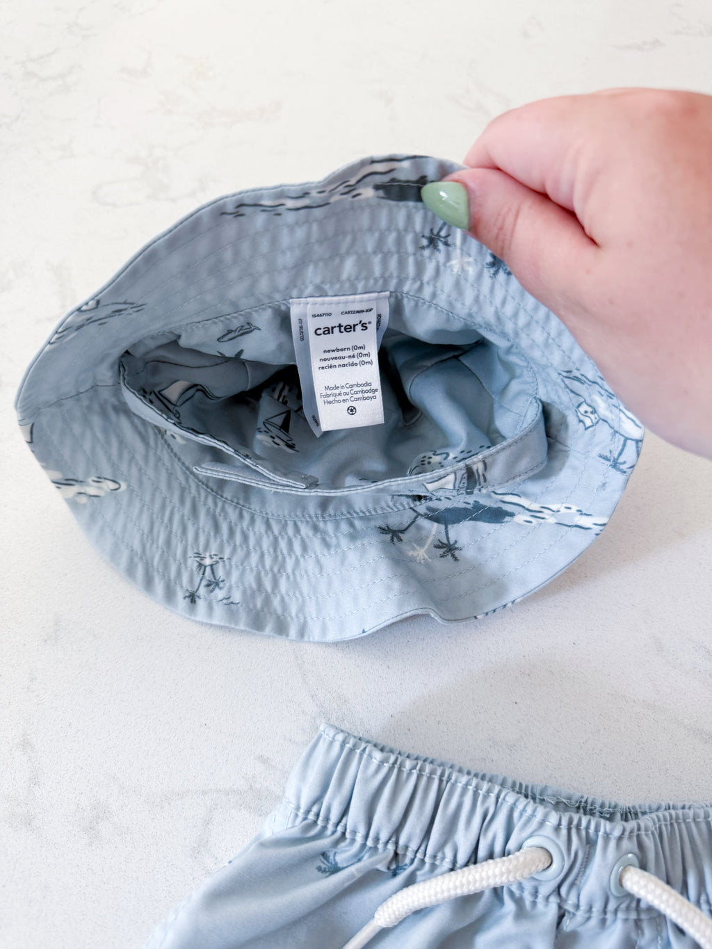 Carters- newborn- VGUC- light blue swim trunks with matching hat