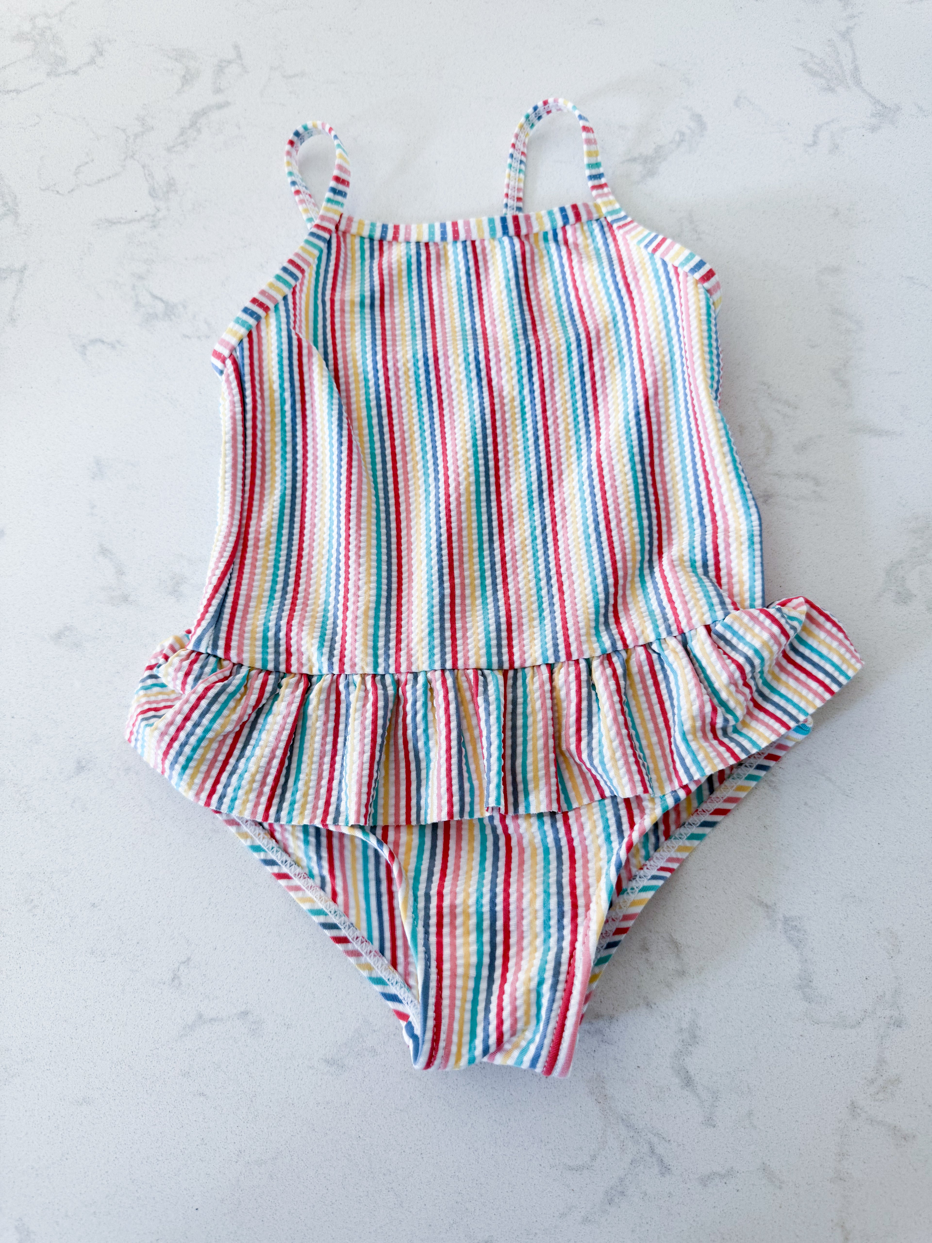 Primark- 12-18m- VGUC- rainbow coloured thin vertical striped swim suit with ruffle skirt
