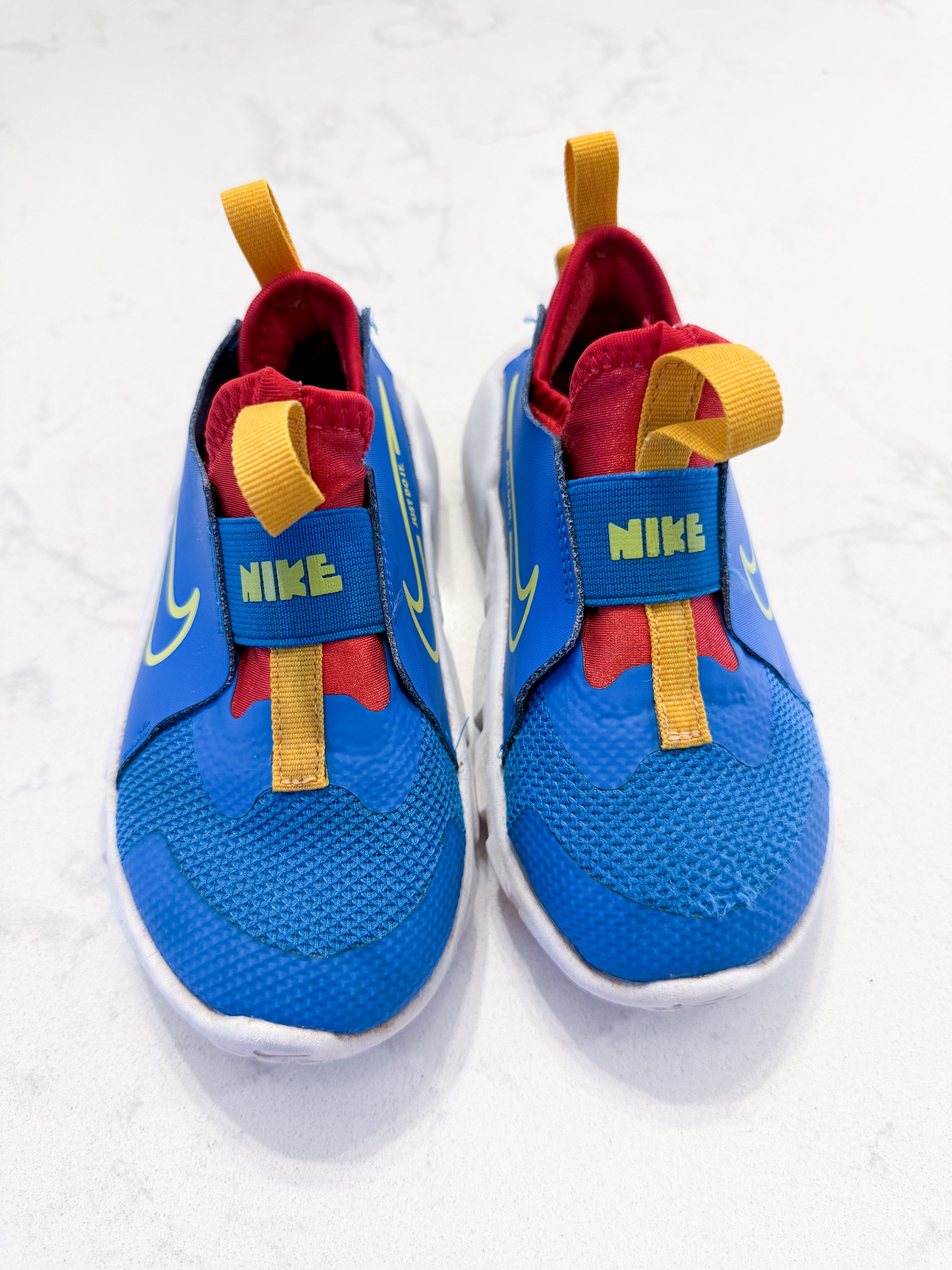 Nike- 9C- PLAY- blue slip on Nike shoes with red and yellow accents