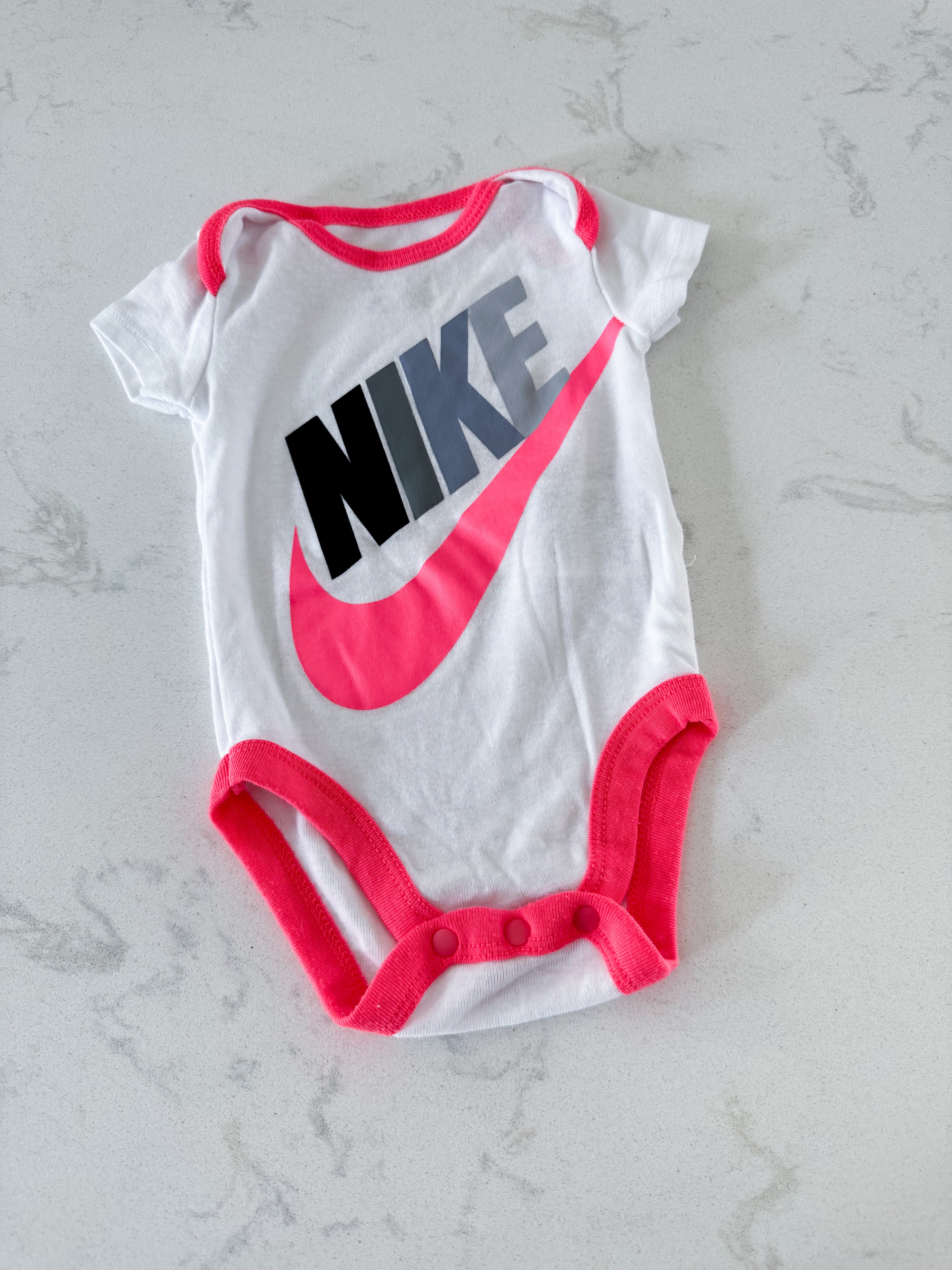 Nike- 0-3m- VGUC- white short sleeve bodysuit with bright pink trim