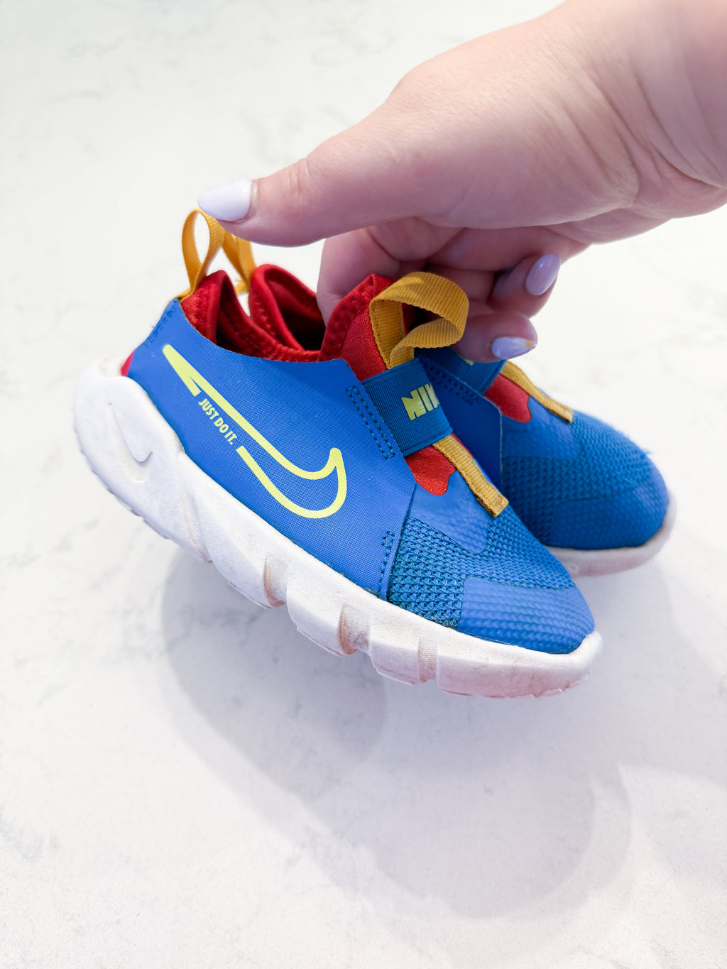 Nike- 9C- PLAY- blue slip on Nike shoes with red and yellow accents