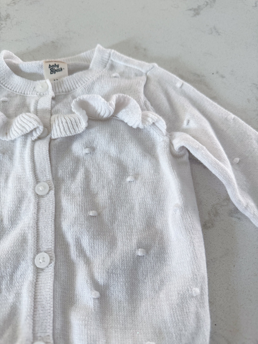 Baby B’gosh- 6m- VGUC- white sparkly knit cardigan with raised bumps and ruffles
