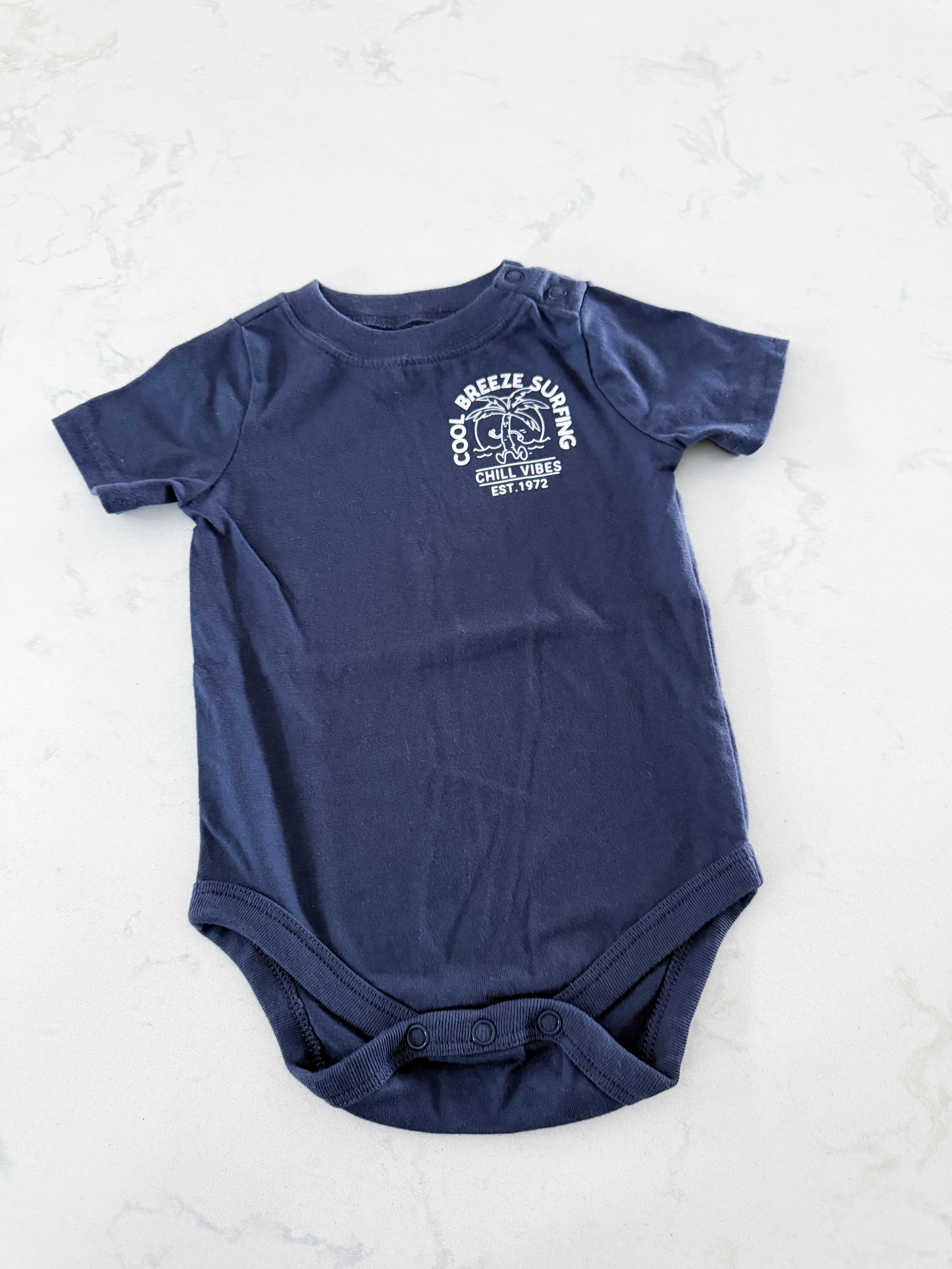 Garanimals- 6-9m- VGUC- navy blue short sleeve bodysuit with “cool breeze surfing”