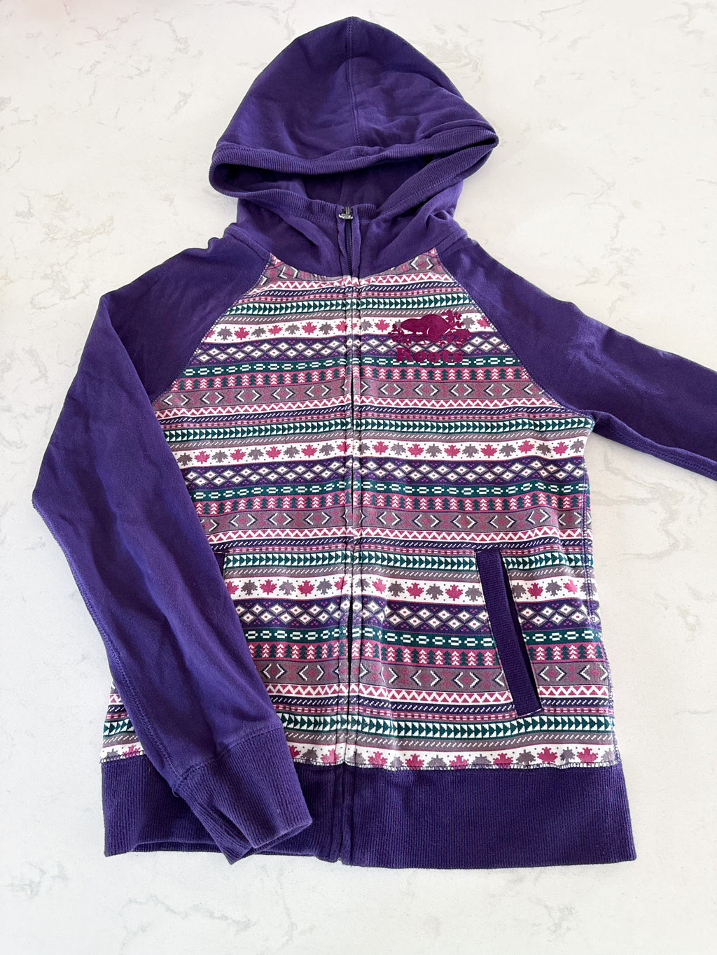 Roots- 11-12Y- GUC- purple patterned zip up with medium purple logo