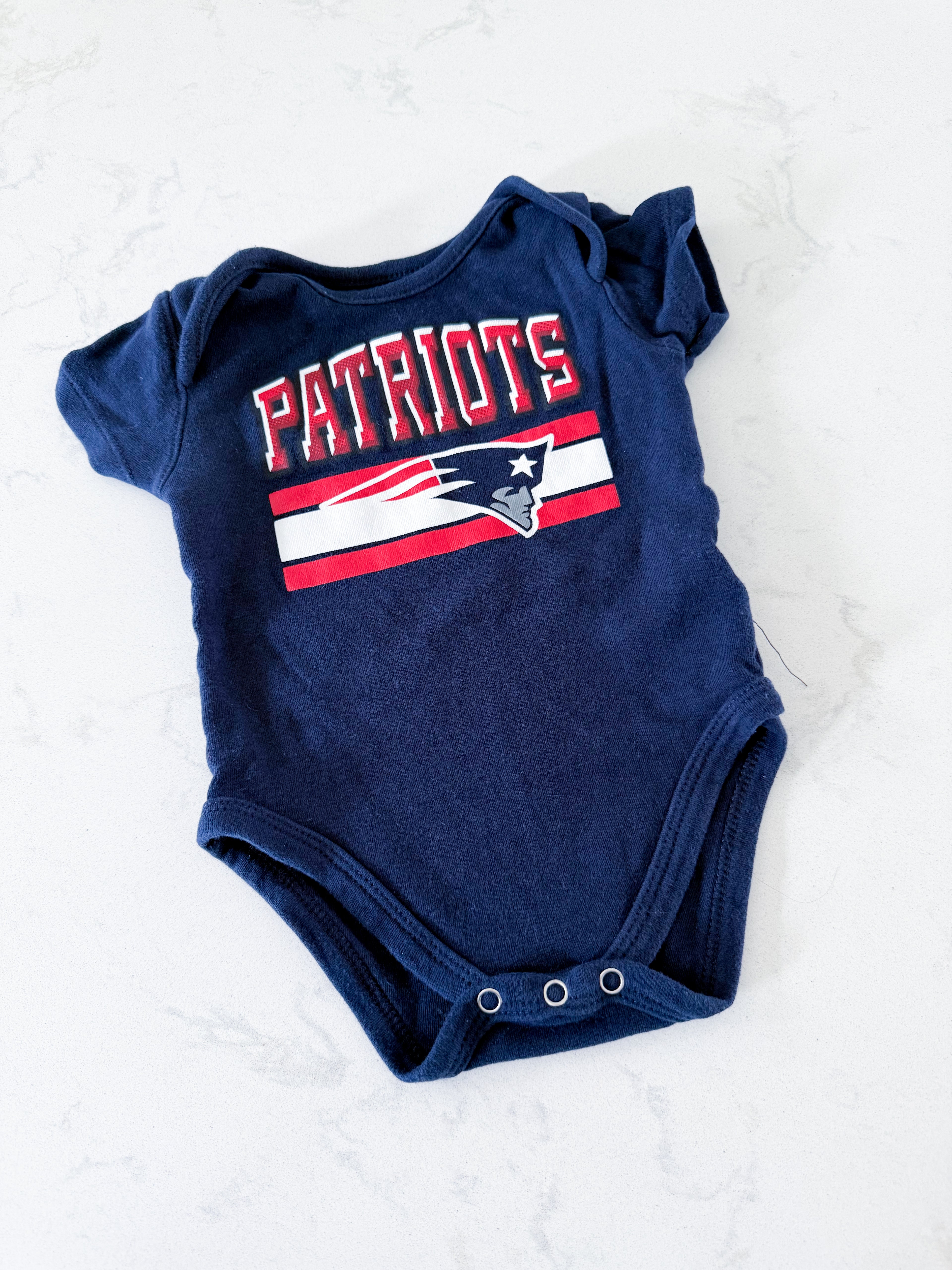 NFL- 3-6m- GUC- navy blue short sleeve bodysuit with patriots graphics