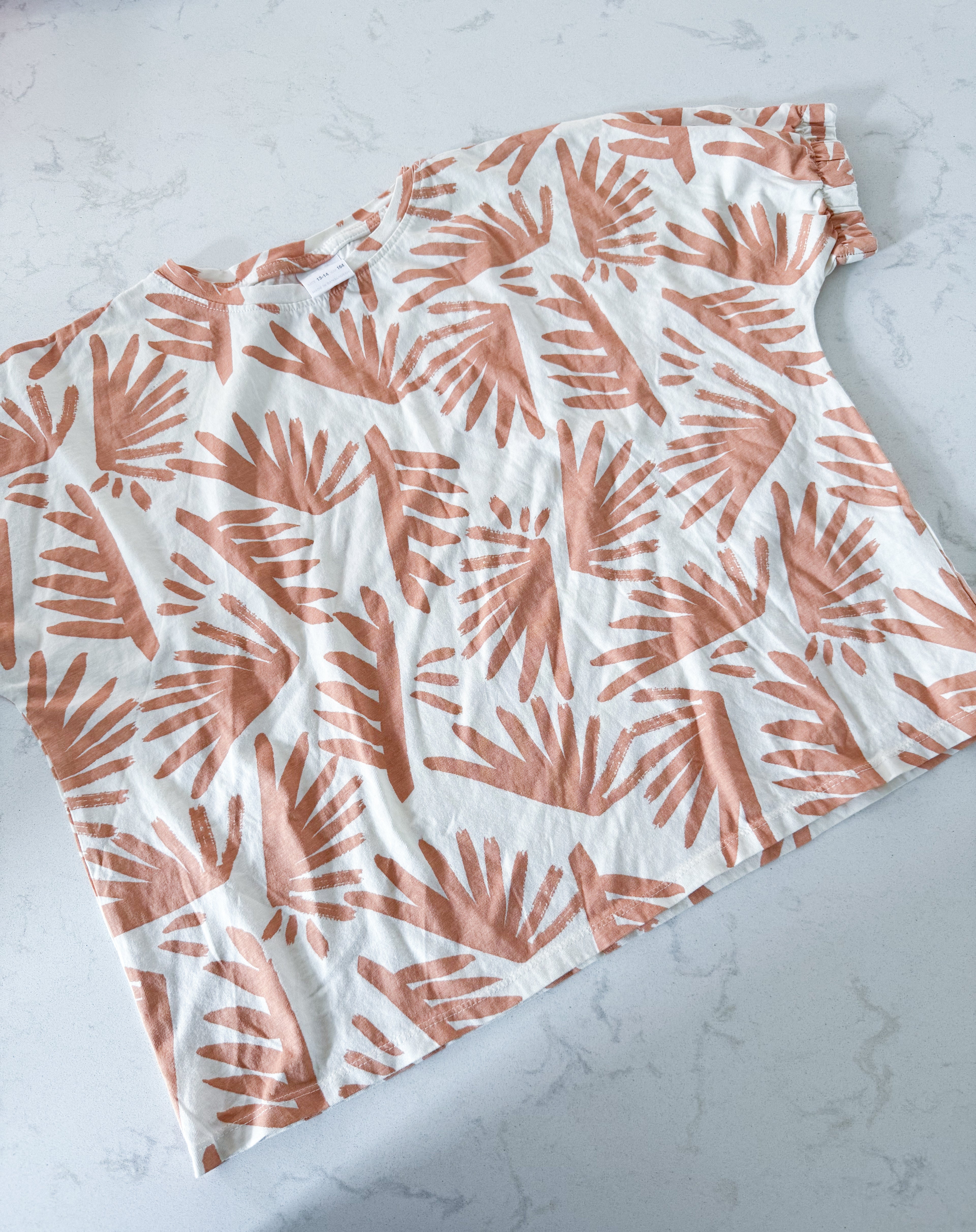 Zara- 13-14Y- VGUC- cream coloured short t shirt with tan tropical leaves