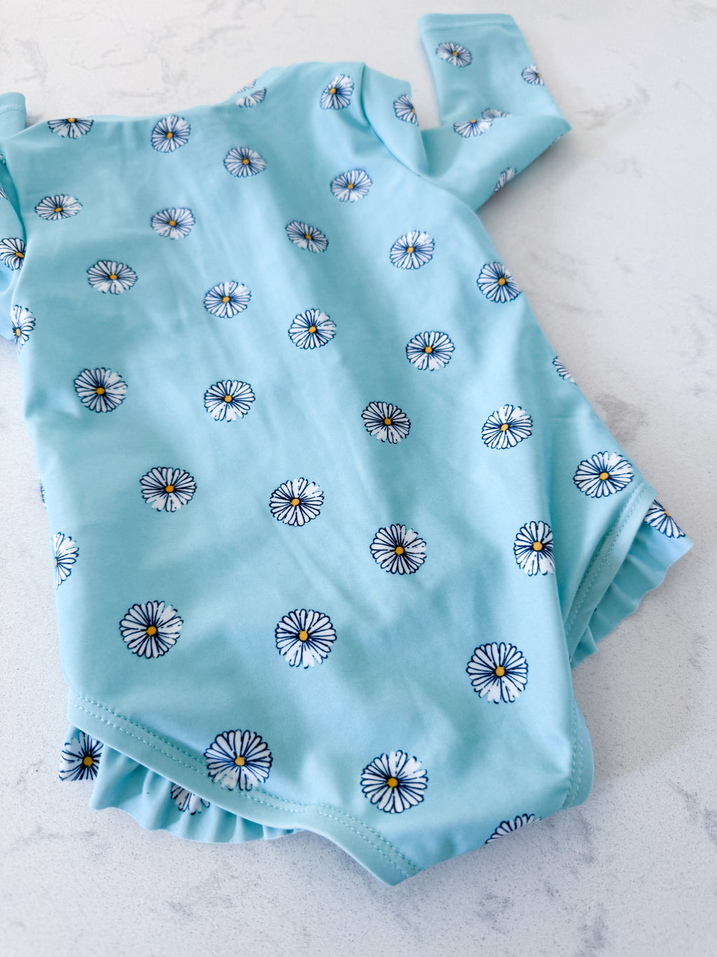 Carters-3-6m- VGUC- blue long sleeve swimsuit with white daisies