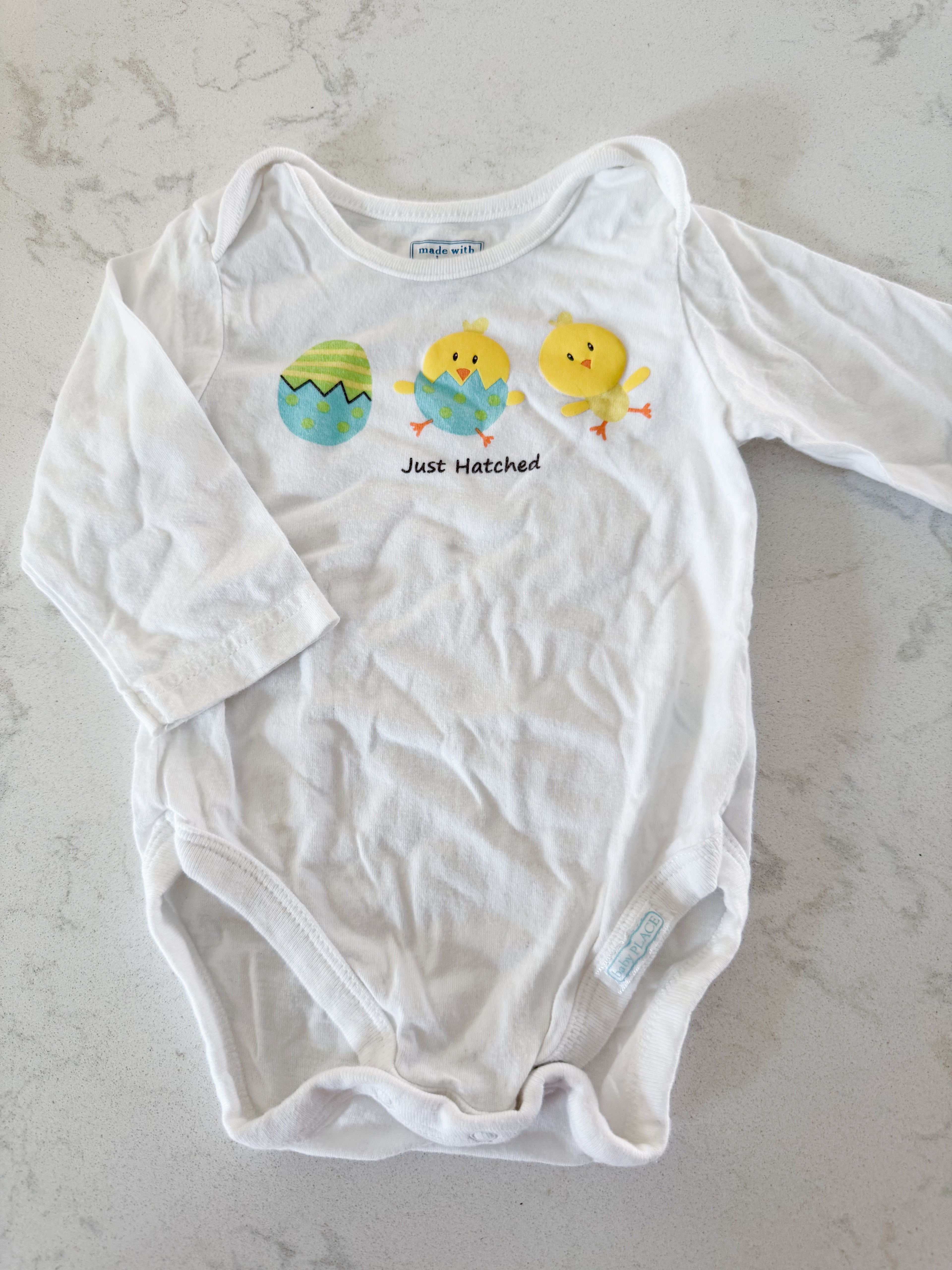The Children’s Place- 3-6m- GUC- white long sleeve bodysuit with “just hatched”