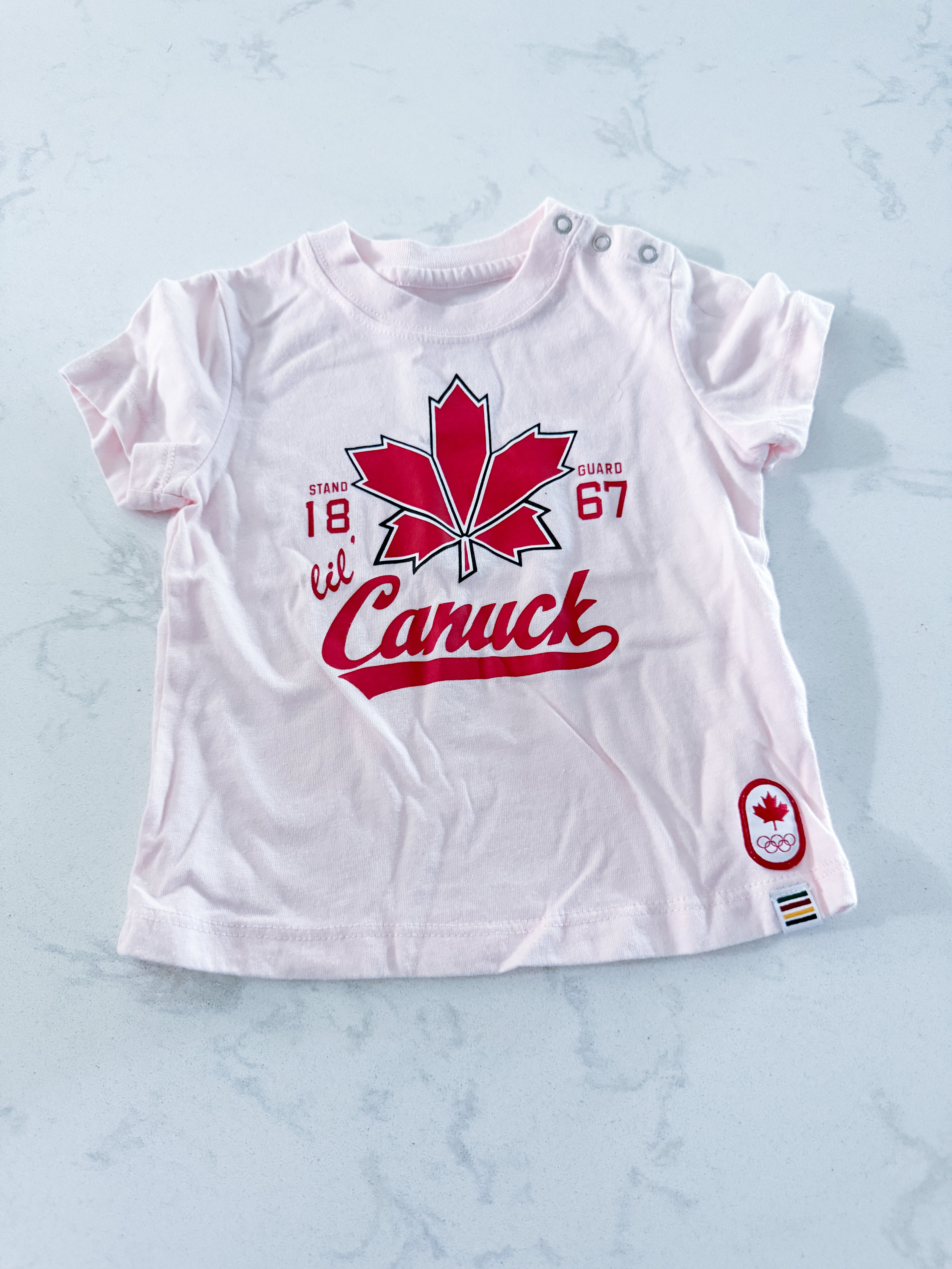 HBC- 0-6m- VGUC- pink t shirt with Canuck graphic on front