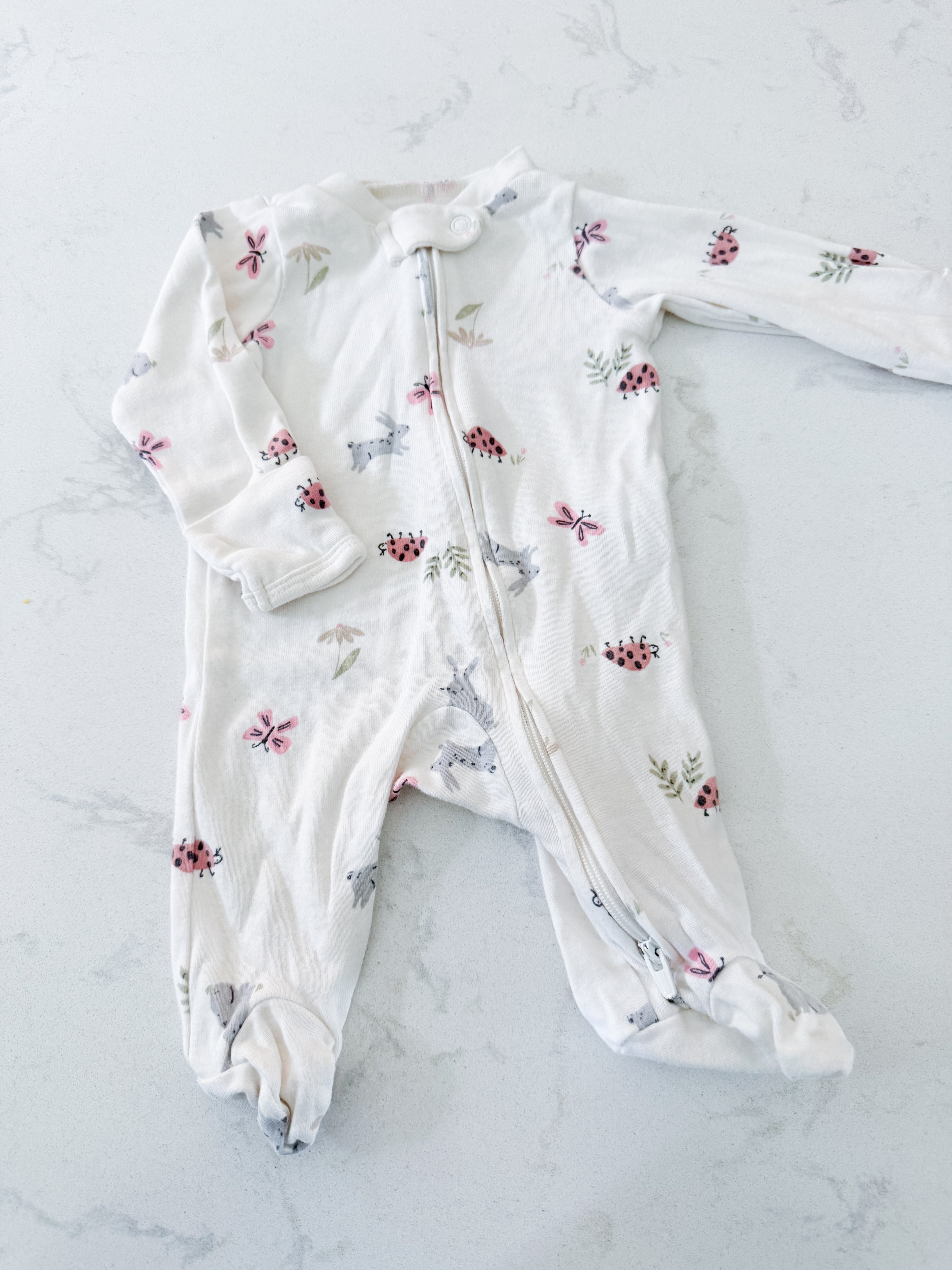 Carters- newborn- GUC- white footie pajamas with spring pattern