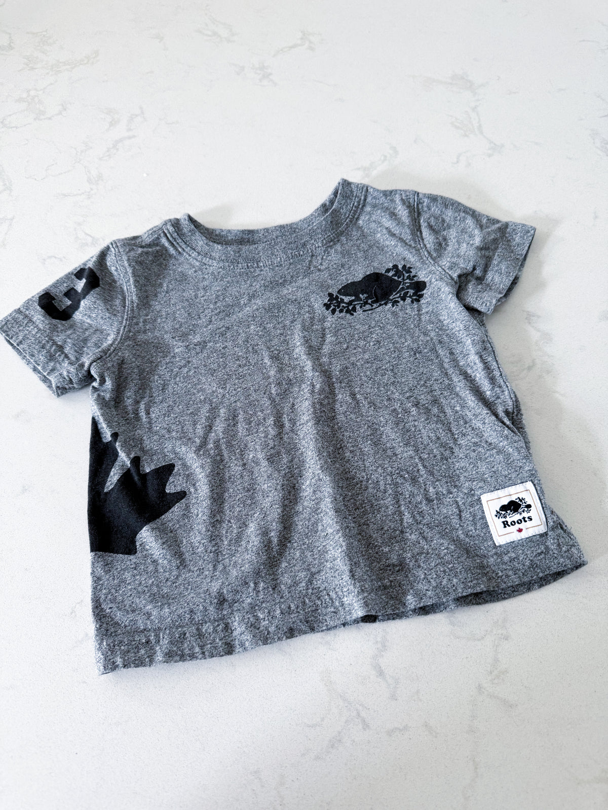 Roots- 12-18m- VGUC- Grey t shirt with black Canada graphics and black Roots logo