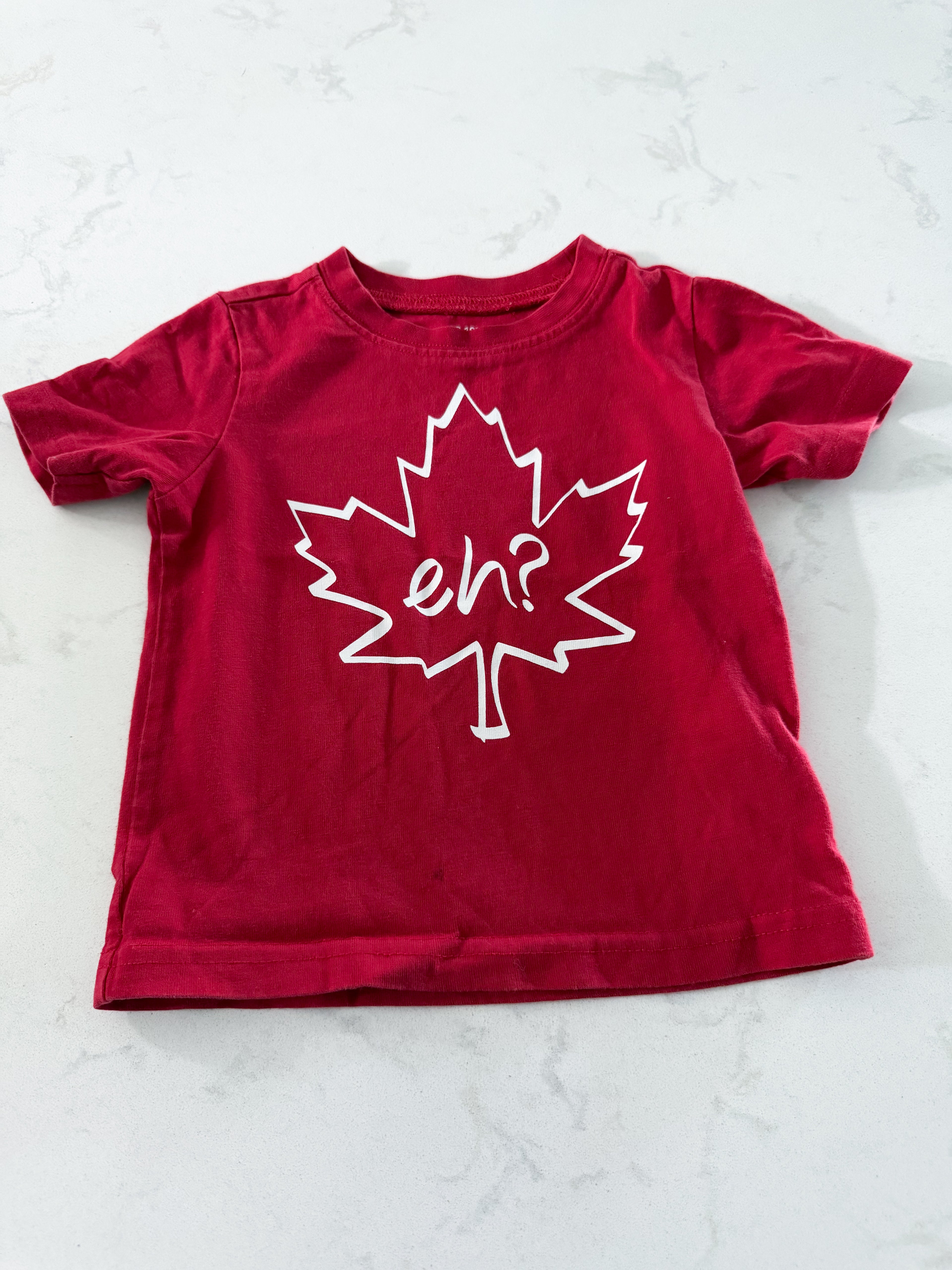 No brand- 12-18m- VGUC- red t shirt with leaf and “eh?” on front