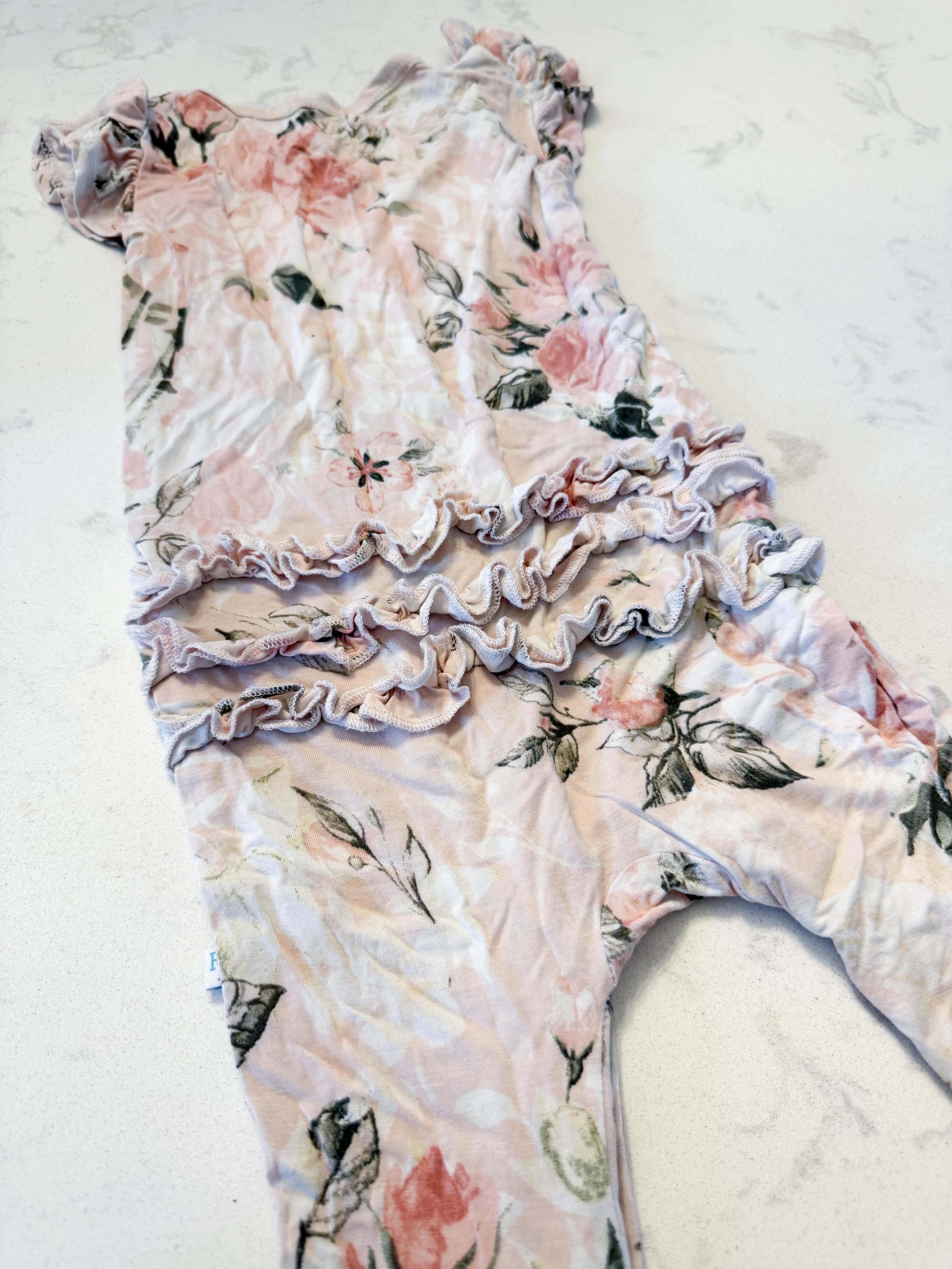Posh Peanut- 9-12m- GUC- light pink short sleeve bamboo romper with rose pattern and ruffle bum