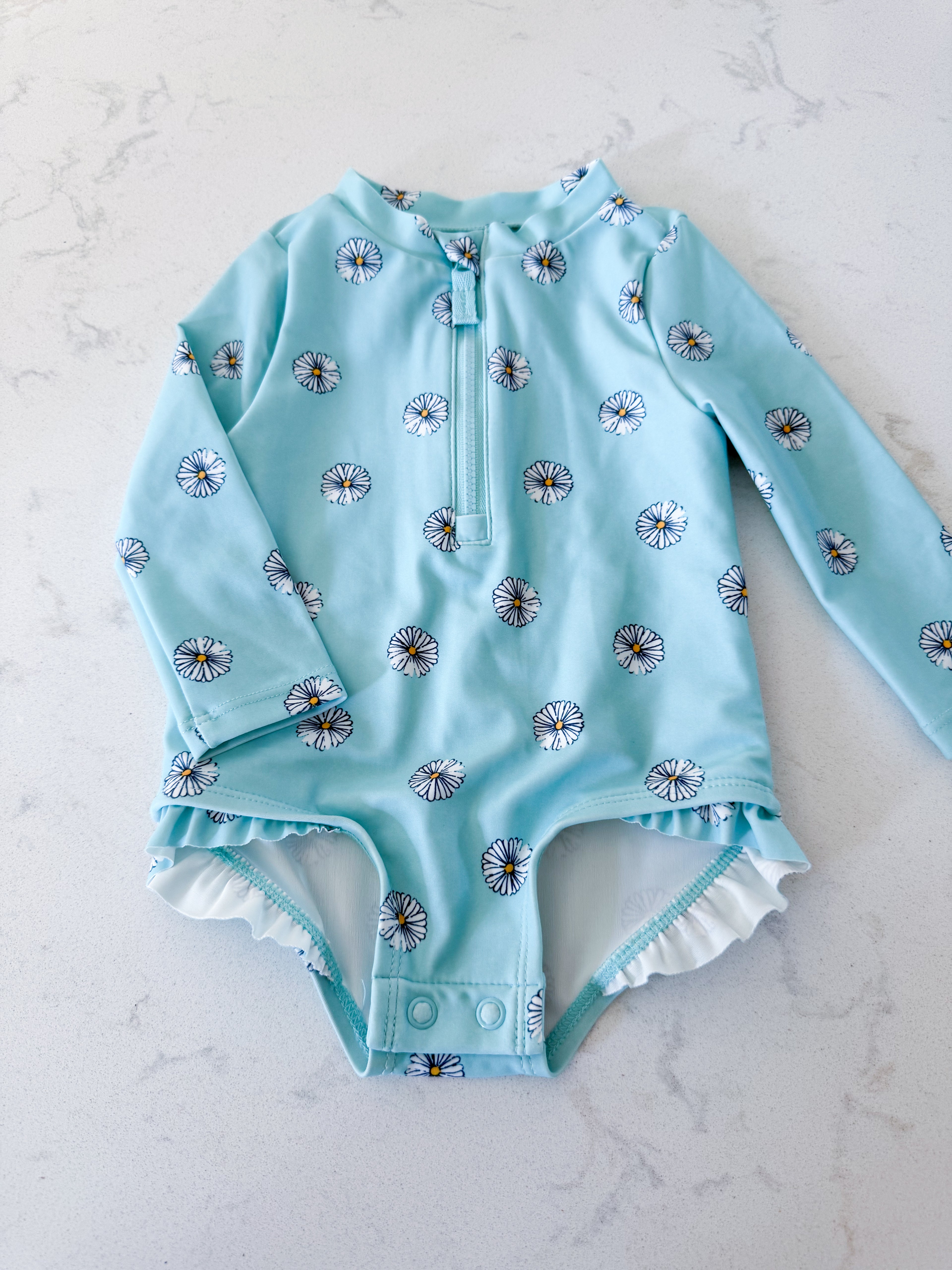 Carters-3-6m- VGUC- blue long sleeve swimsuit with white daisies