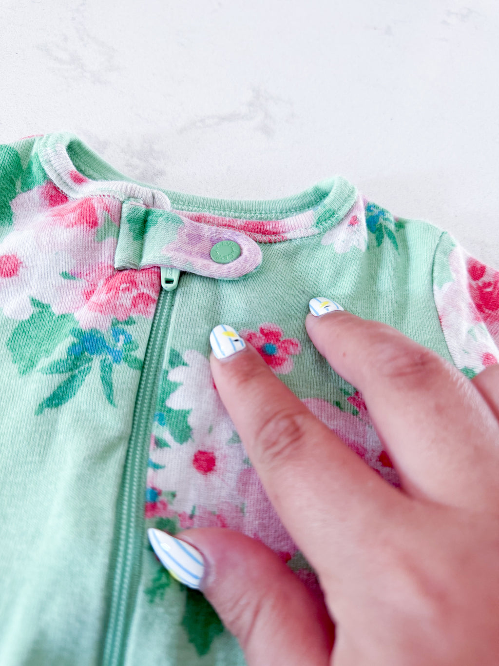 The Children’s Place- 6-9m- PLAY- light green zip up footie pajamas with pink flowers