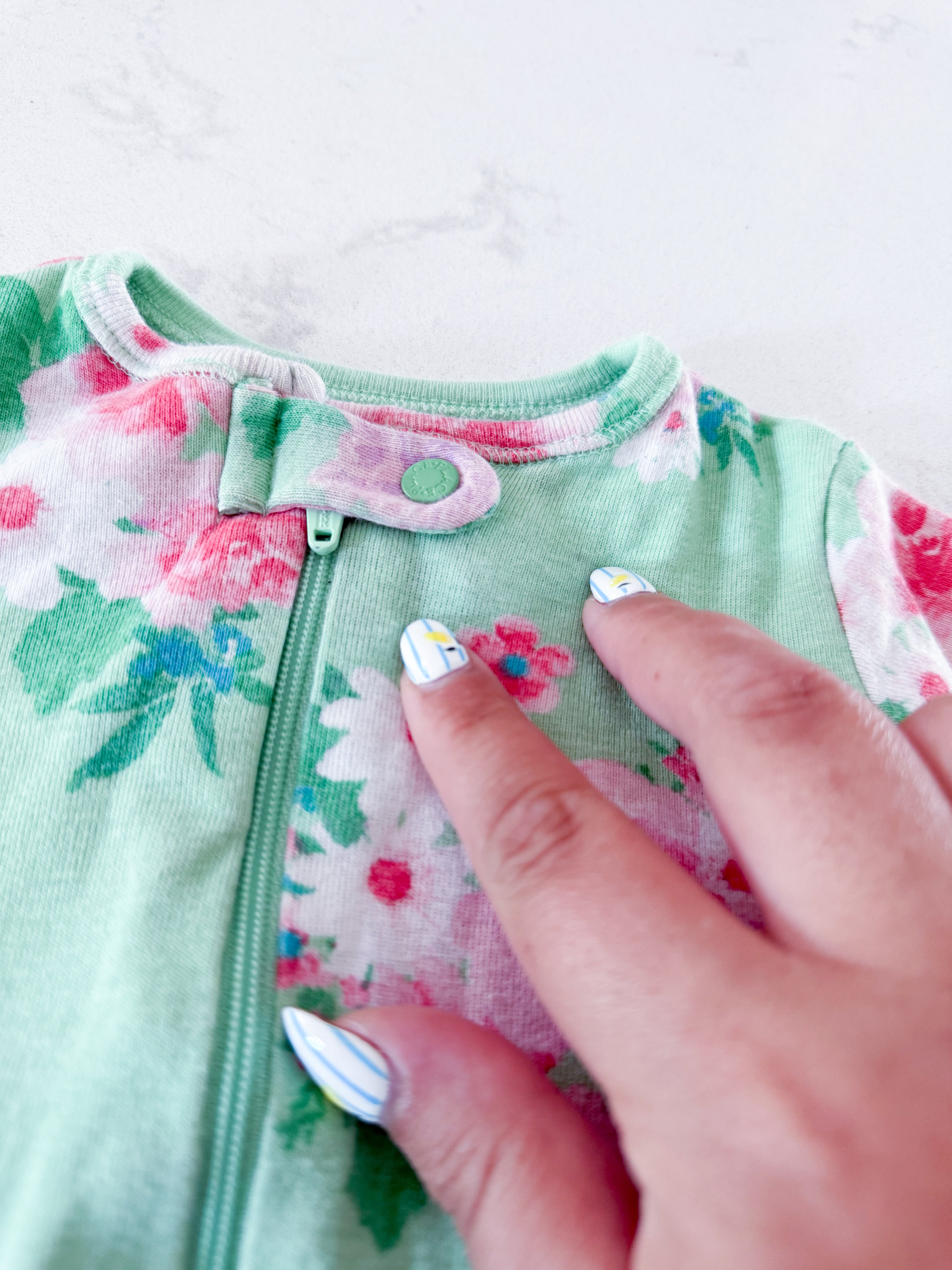 The Children’s Place- 6-9m- PLAY- light green zip up footie pajamas with pink flowers