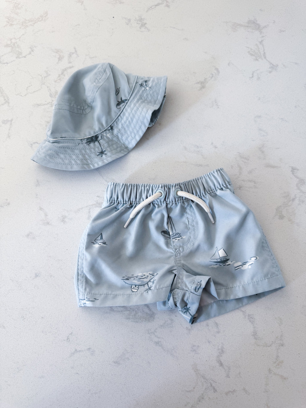 Carters- newborn- VGUC- light blue swim trunks with matching hat