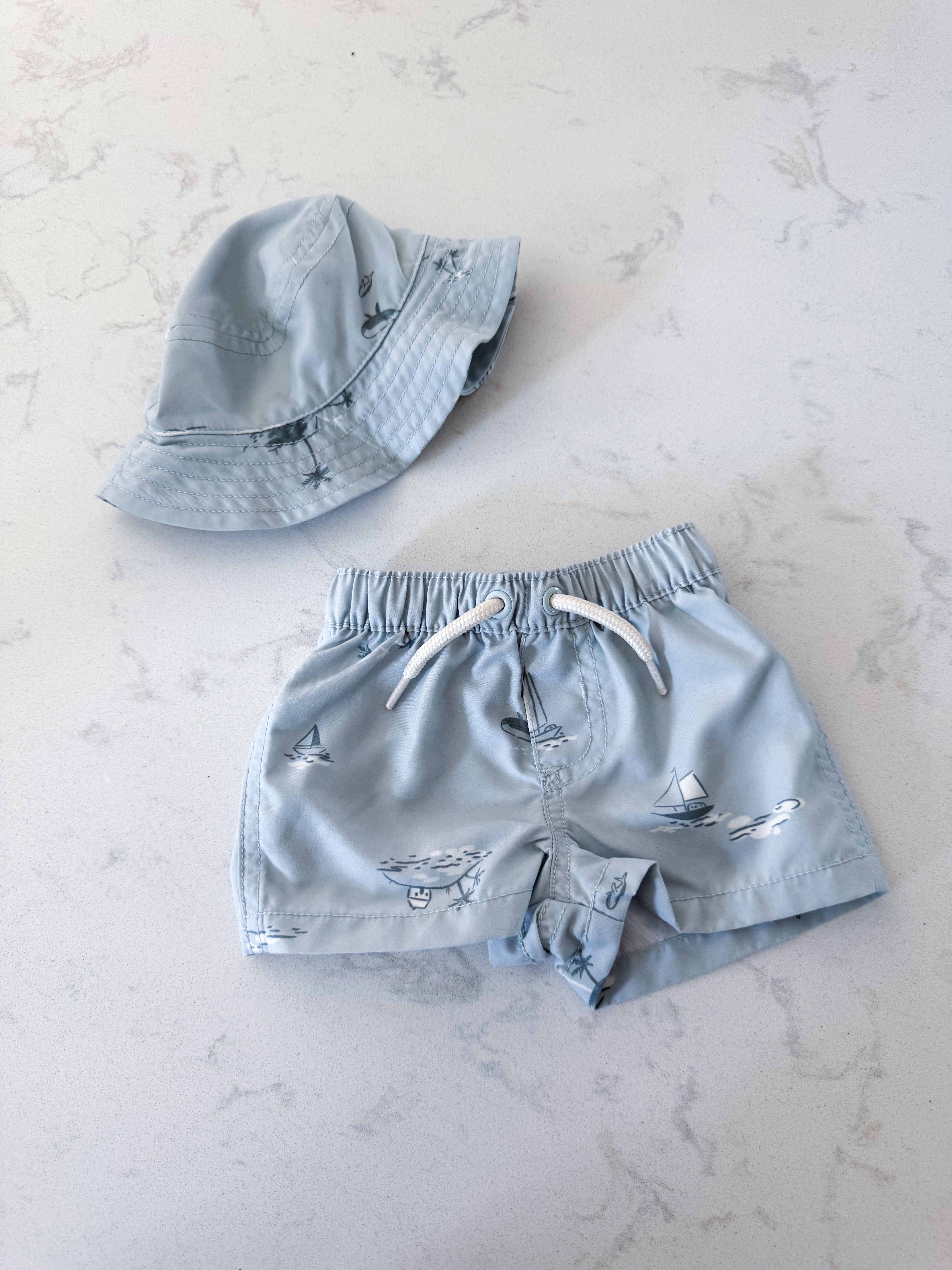 Carters- newborn- VGUC- light blue swim trunks with matching hat