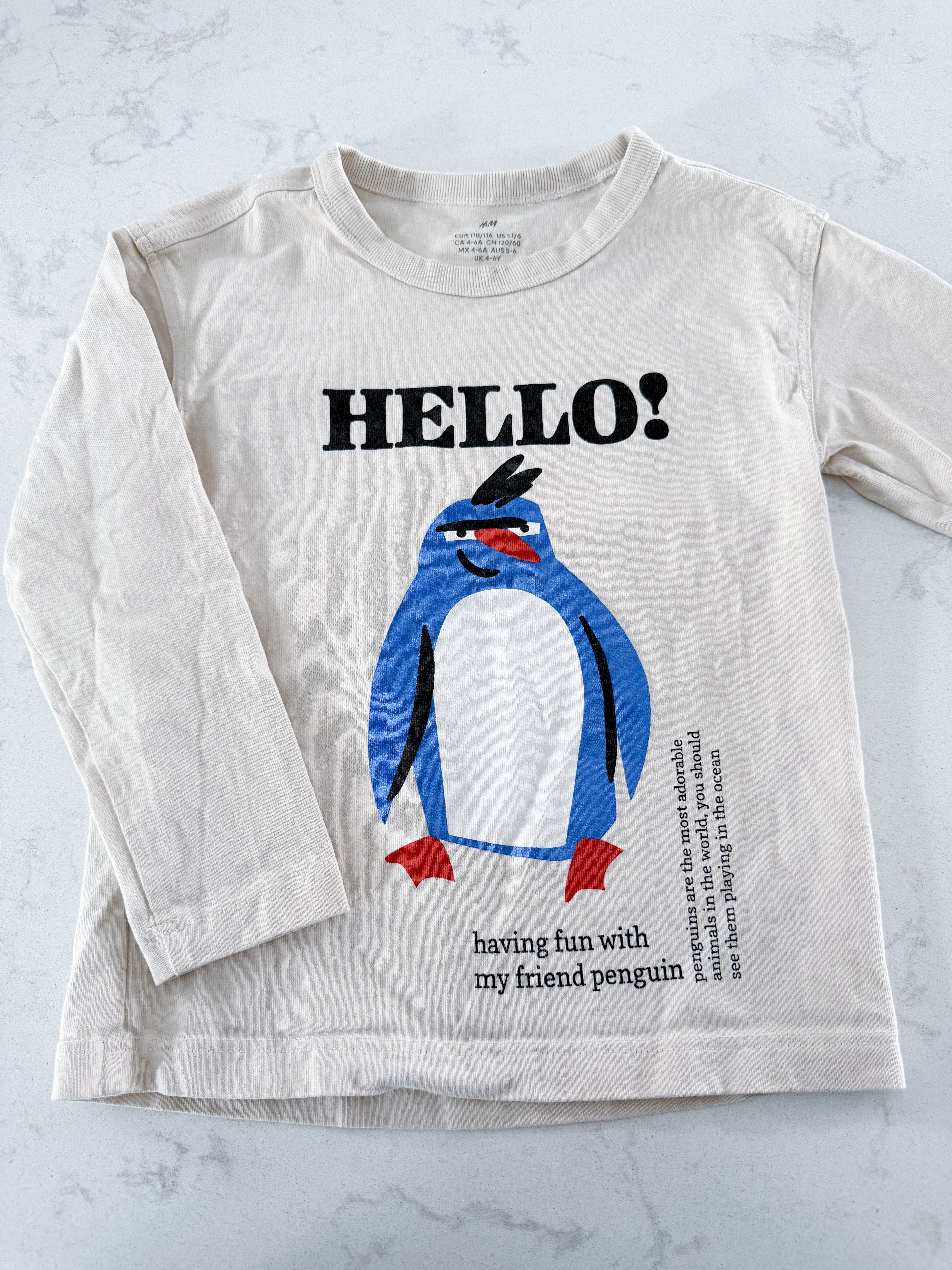 H&M- 5T/6Y- VGUC- light beige long sleeve shirt with blue penguin on front