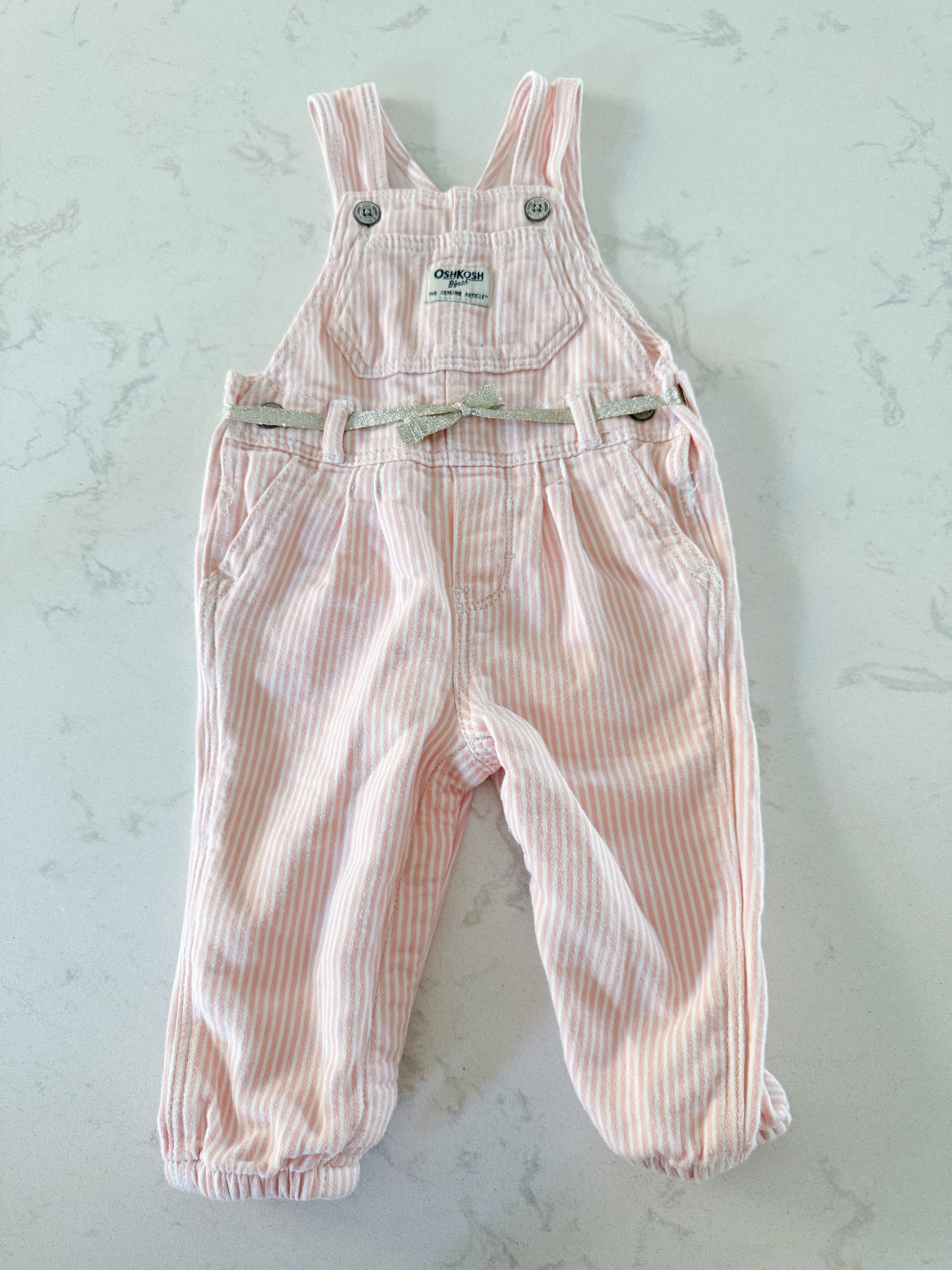 Oshkosh- 12m- GUC- light pink and white striped cloth overalls