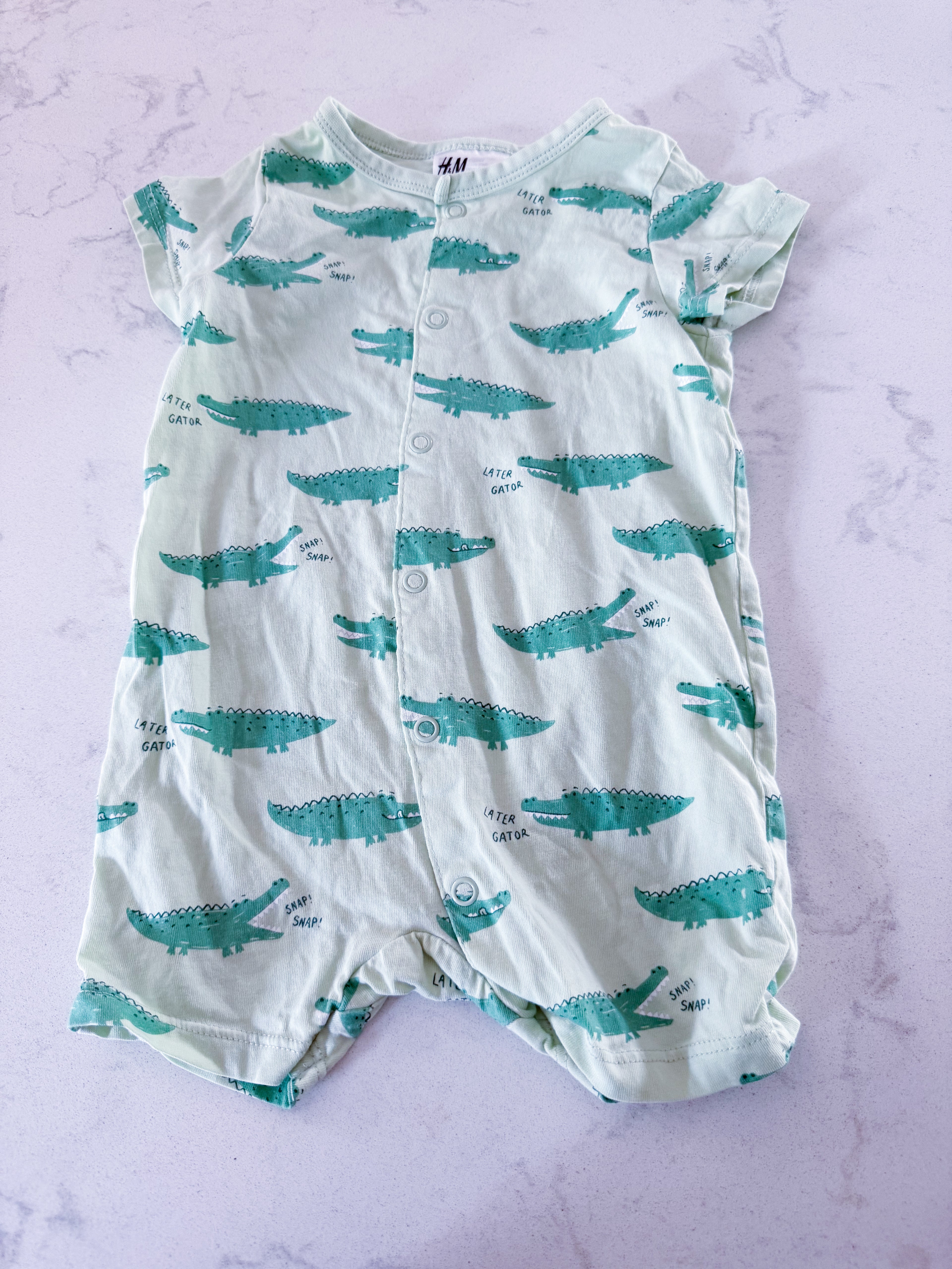 H&M- 6m- VGUC- light green shortie romper/jammies with crocodile pattern