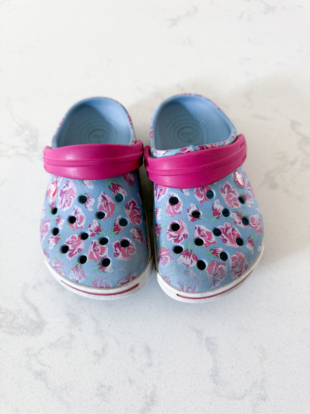 Crocs- 6/7C- GUC- light blue with pink florals slip on crocs