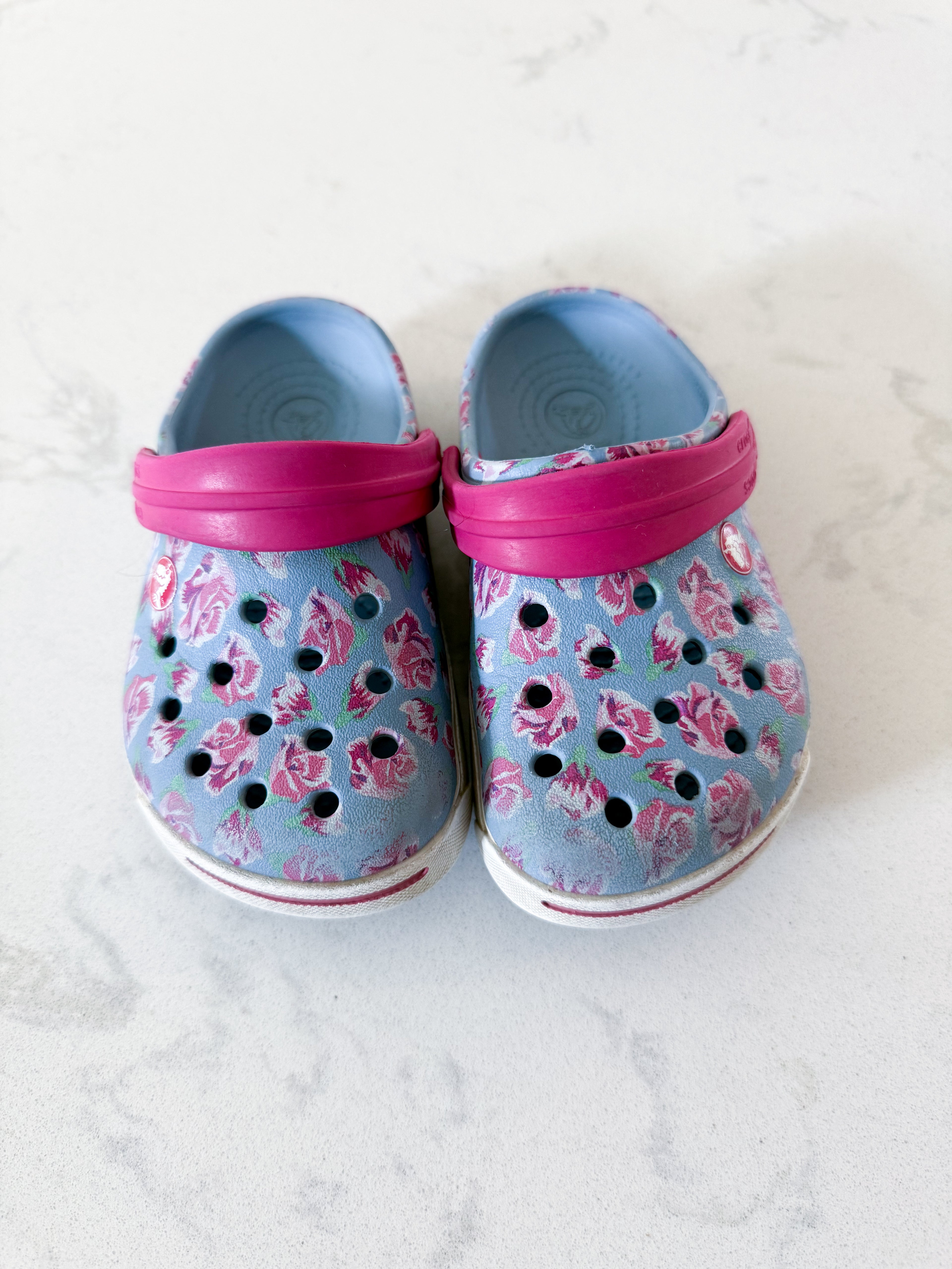 Crocs- 6/7C- GUC- light blue with pink florals slip on crocs