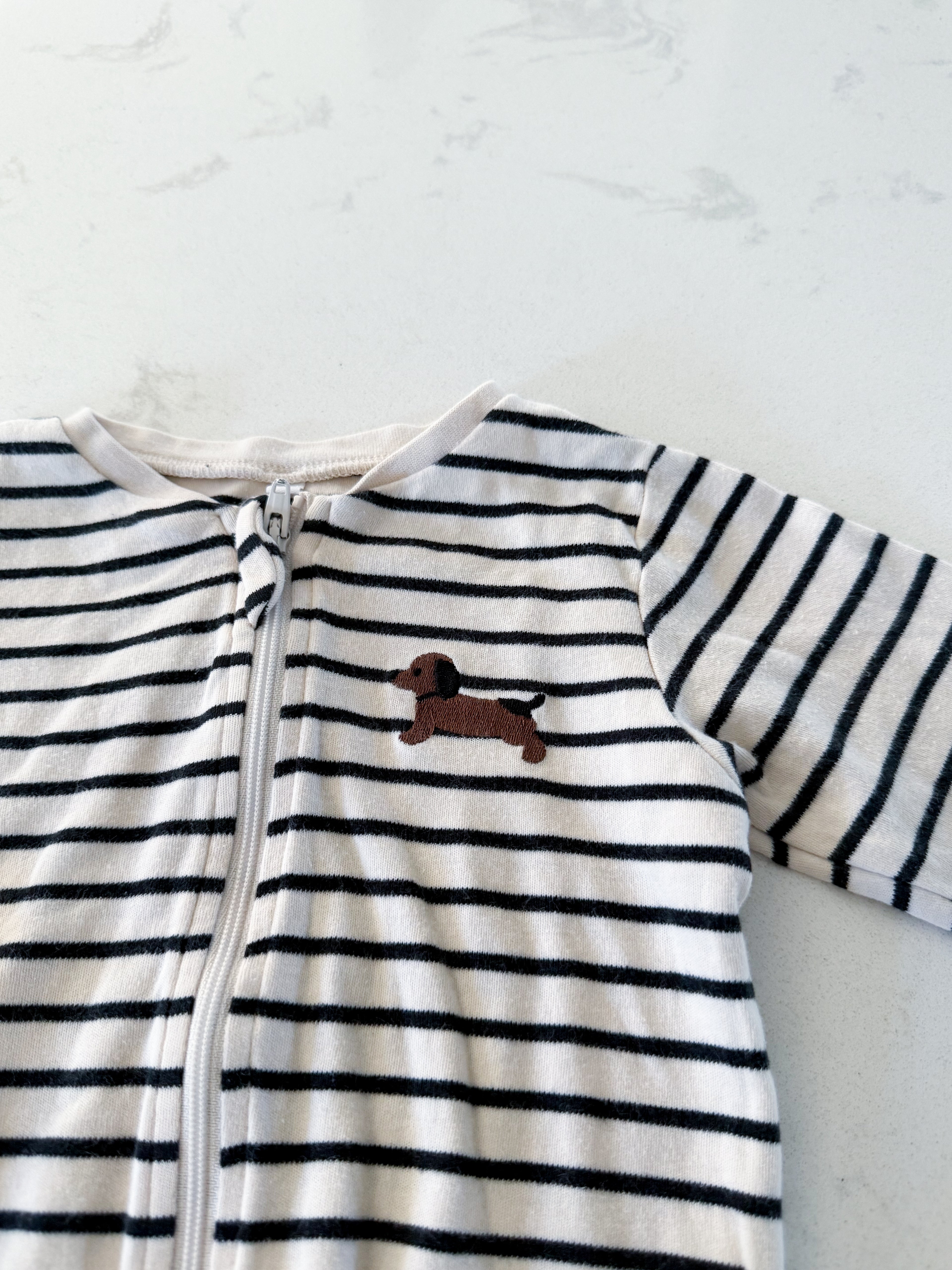 Pekkle- 9m- GUC- cream and black striped footie pajamas with wiener dog