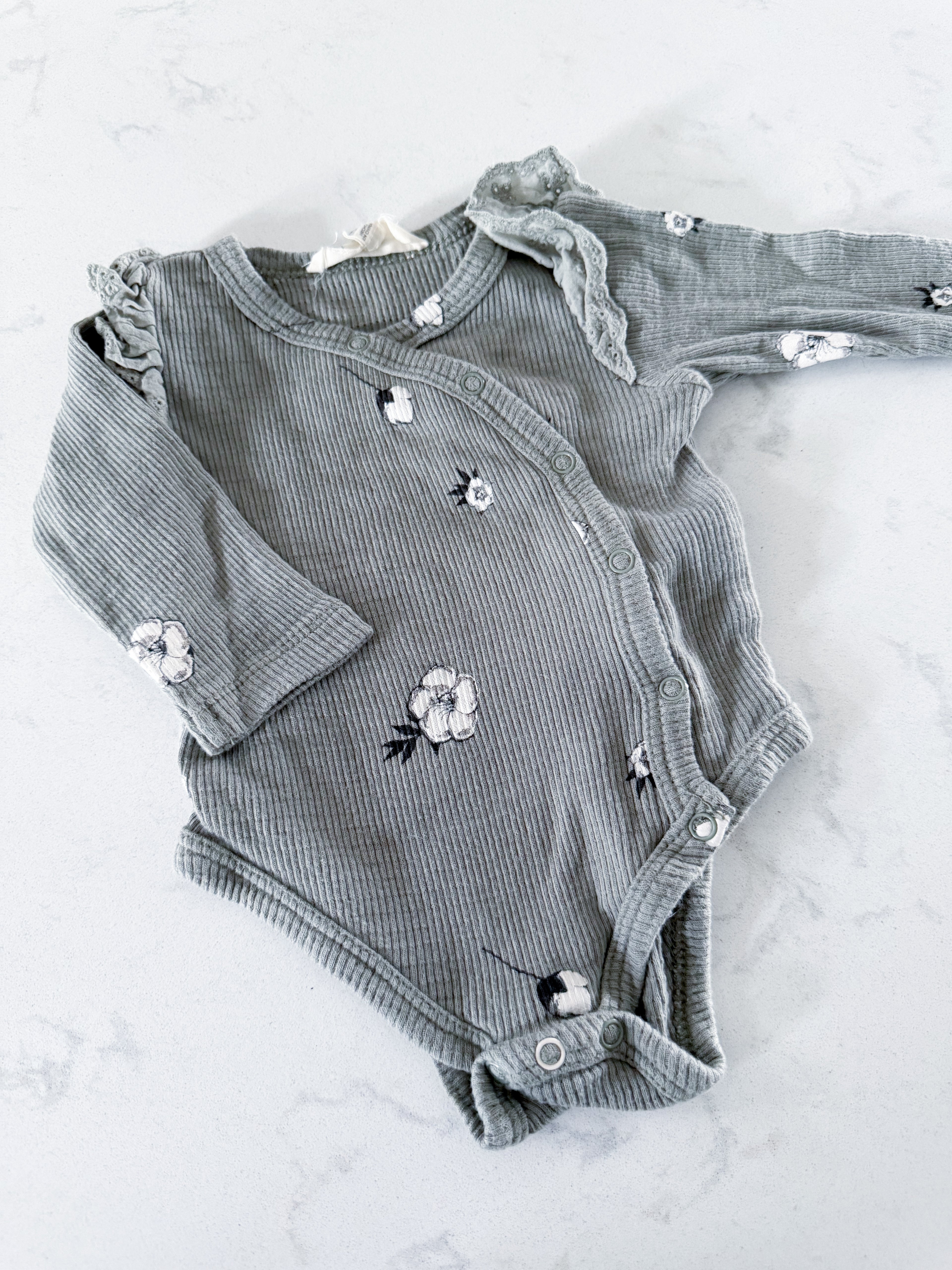Jessica Simpson- 0-3m- GUC- sage green wrap bodysuit with ribs and white florals