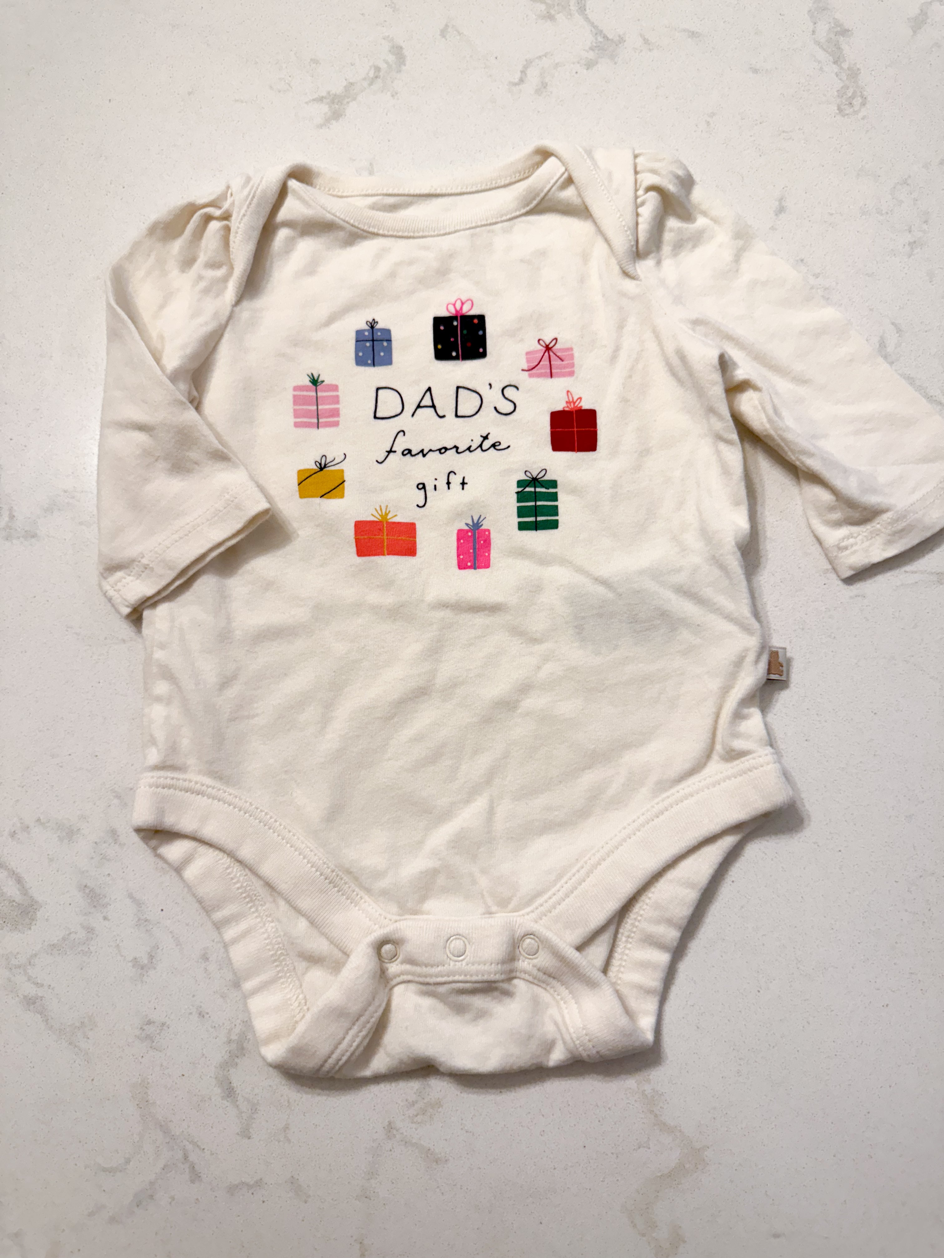 Baby Gap- 0-3m- GUC- cream coloured bodysuit with multicoloured presents
