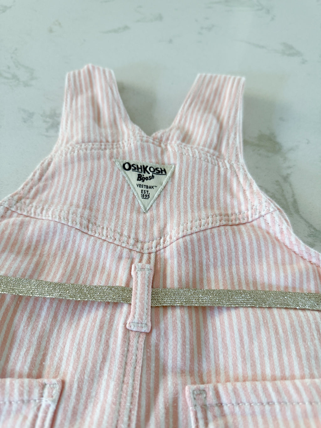 Oshkosh- 12m- GUC- light pink and white striped cloth overalls
